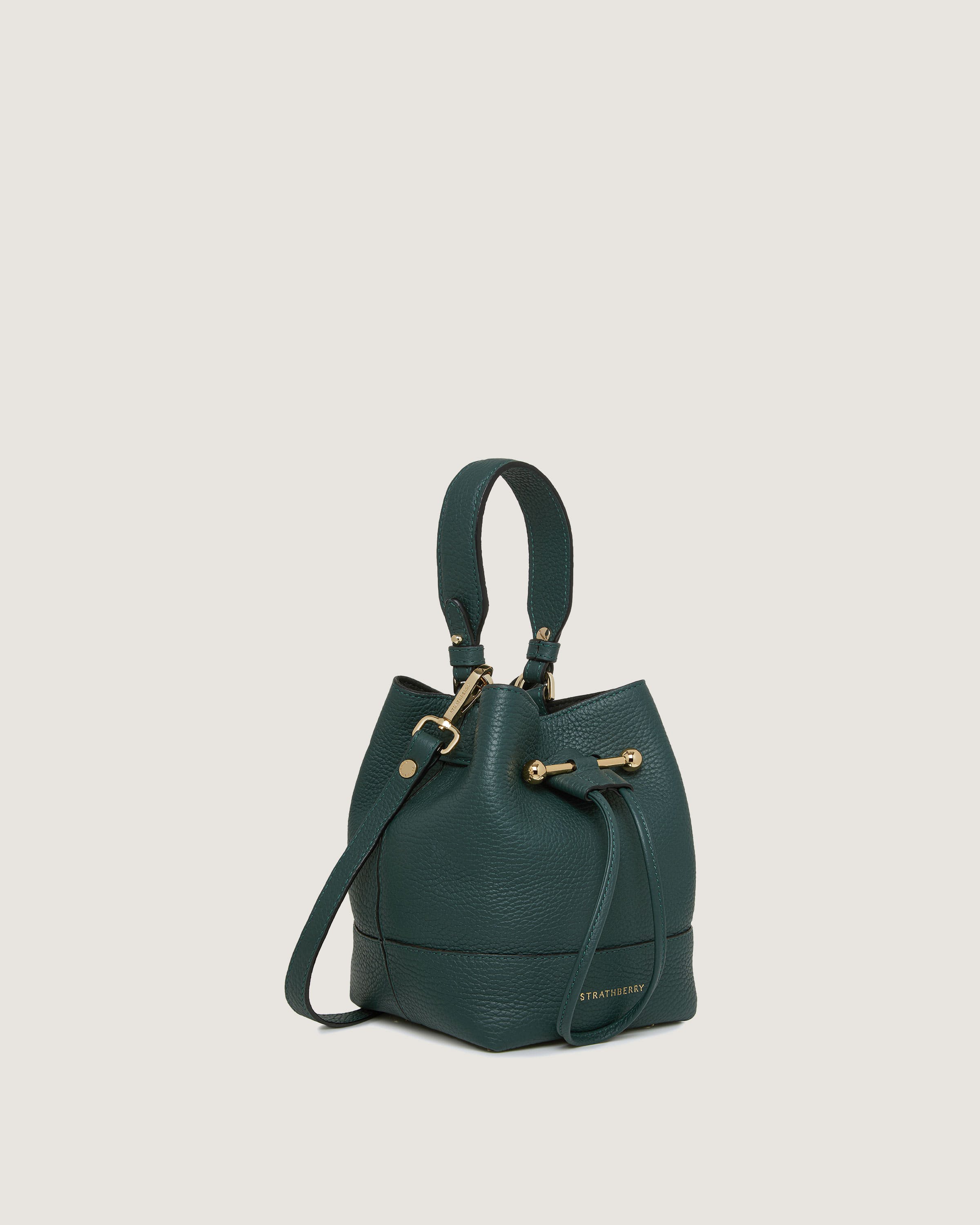 A green handbag on a white background