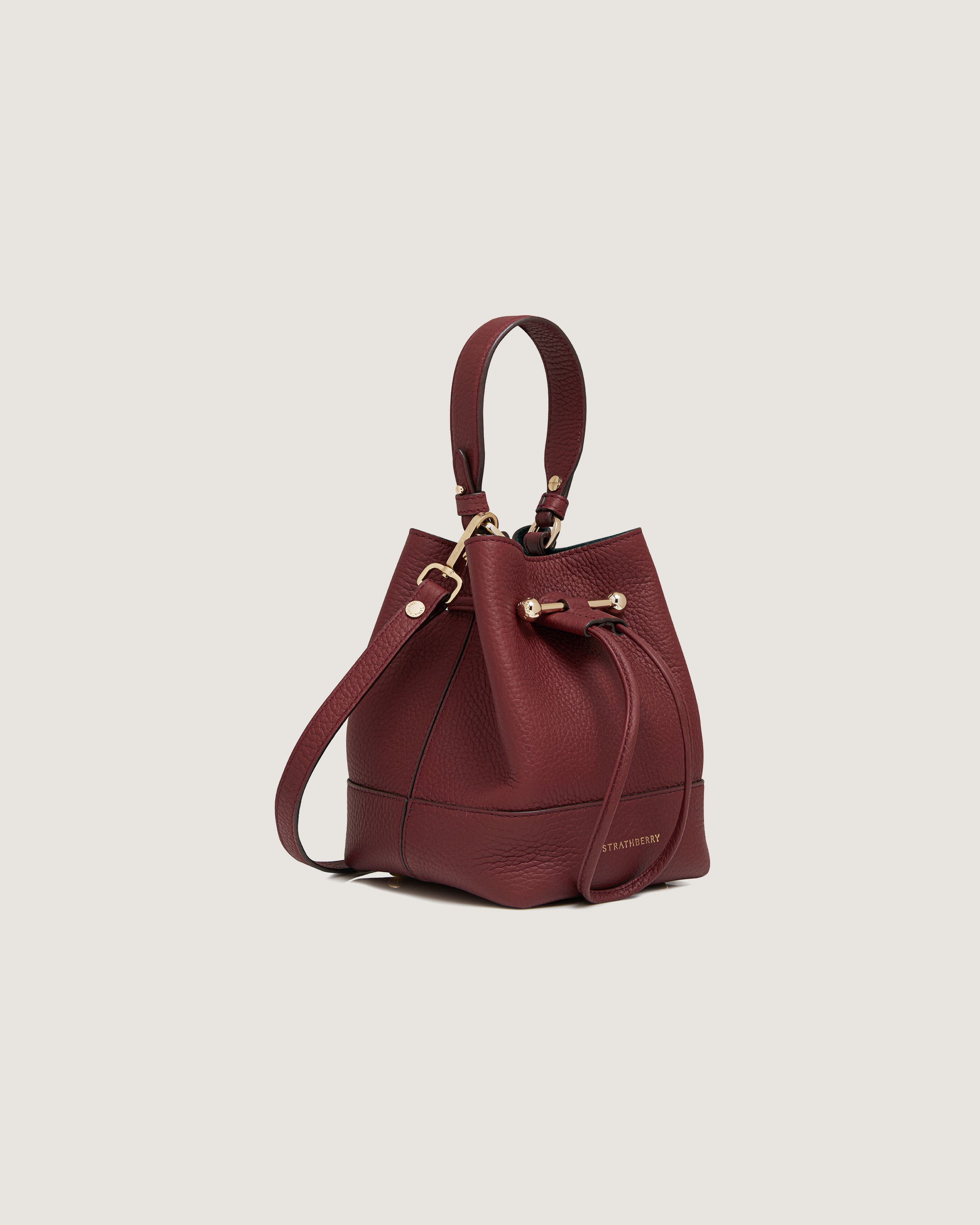 A small red leather bucket bag with gold hardwares