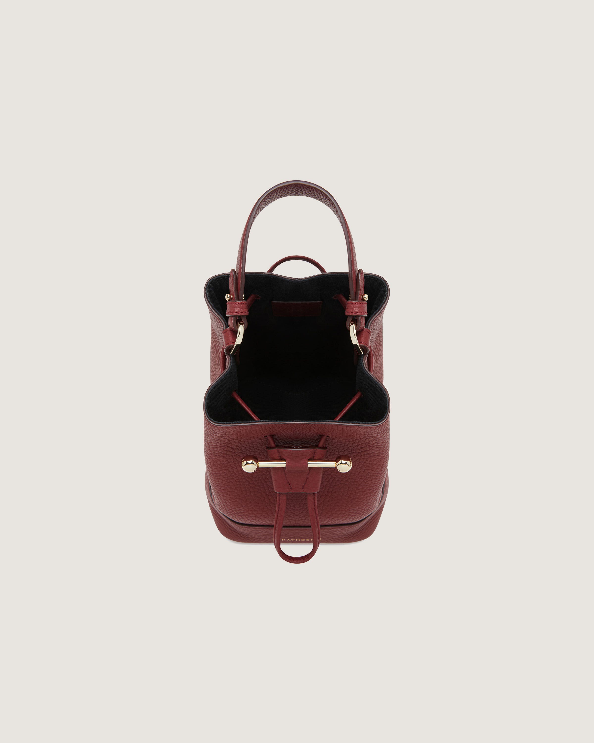 A small red handbag on a white background