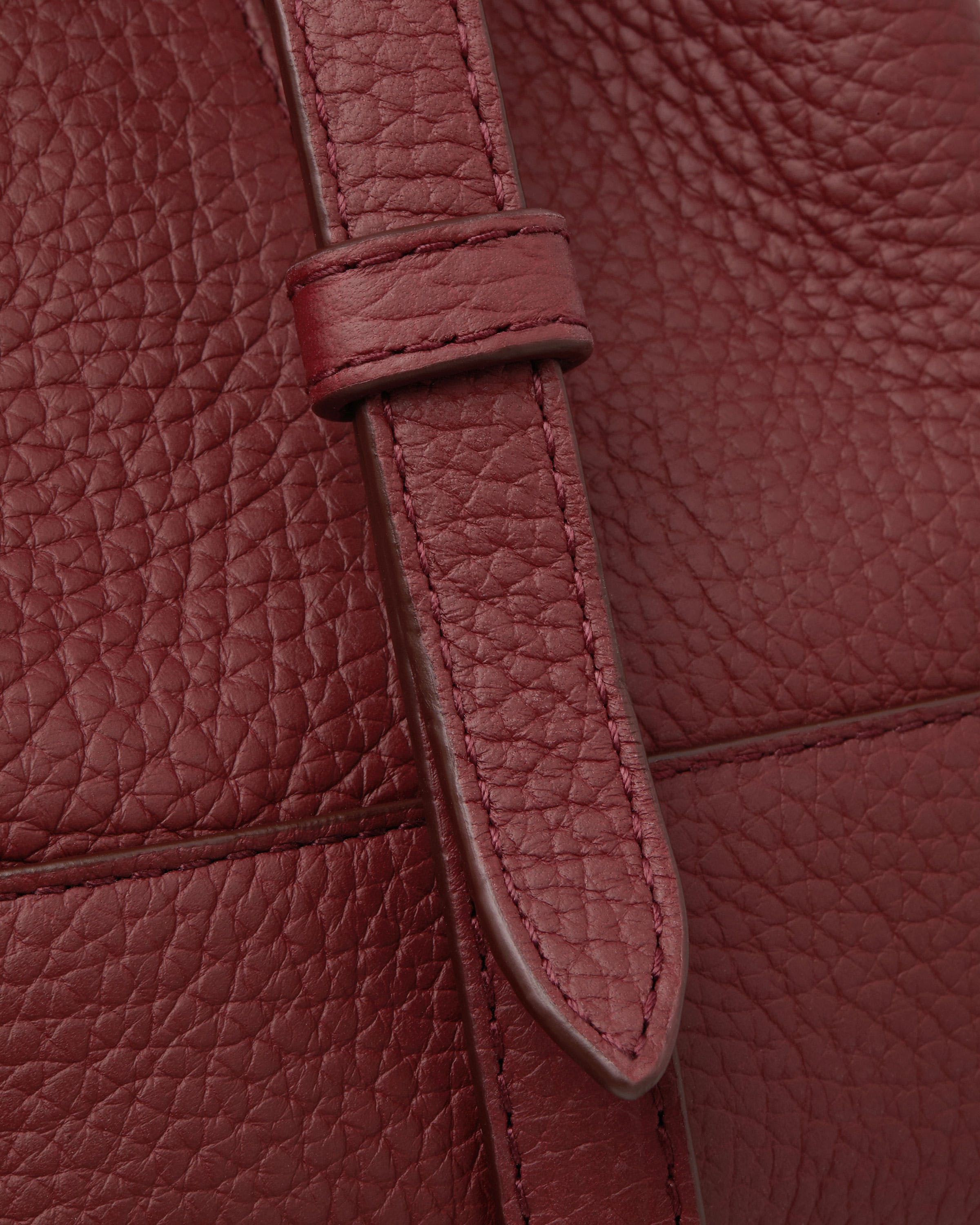 A close up of a red leather purse