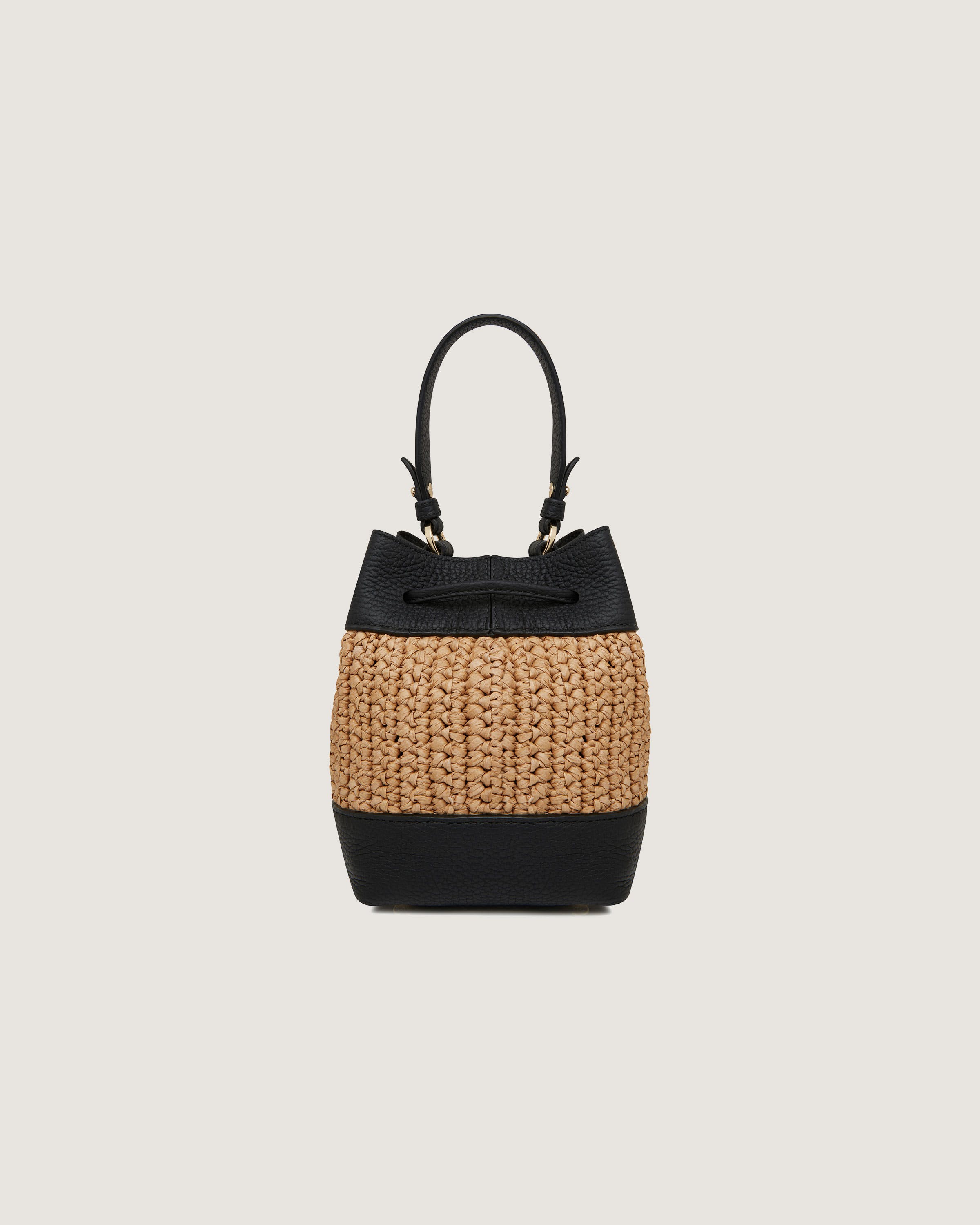 A straw bag with a black handle