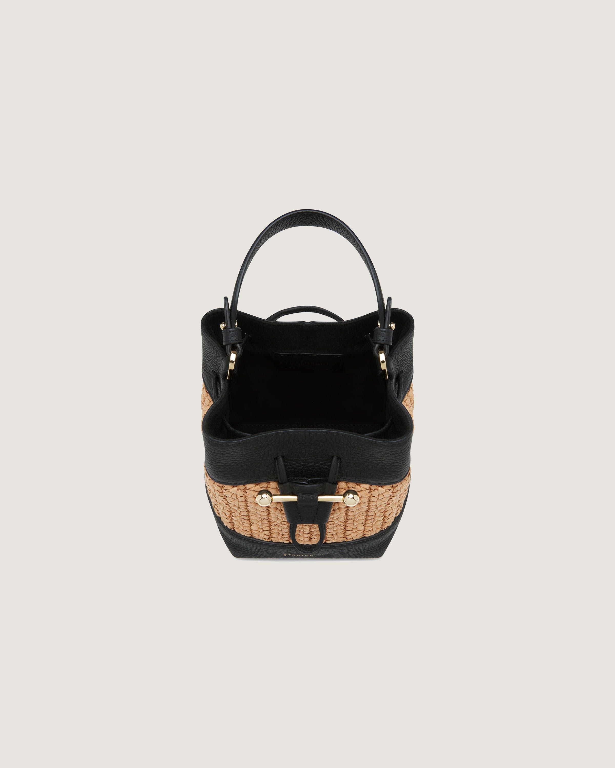 A black and tan handbag on a white background