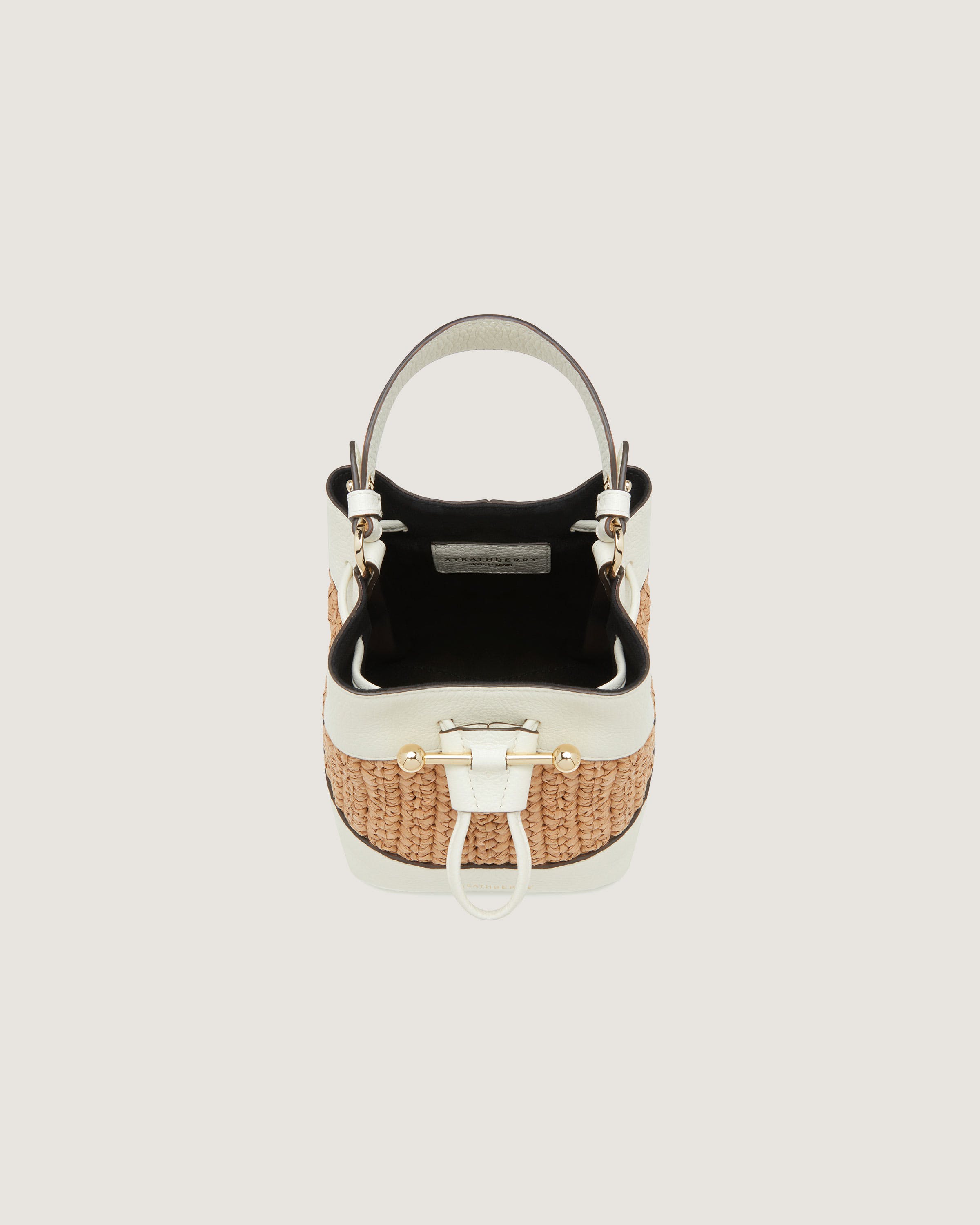 A white and black handbag with a handle