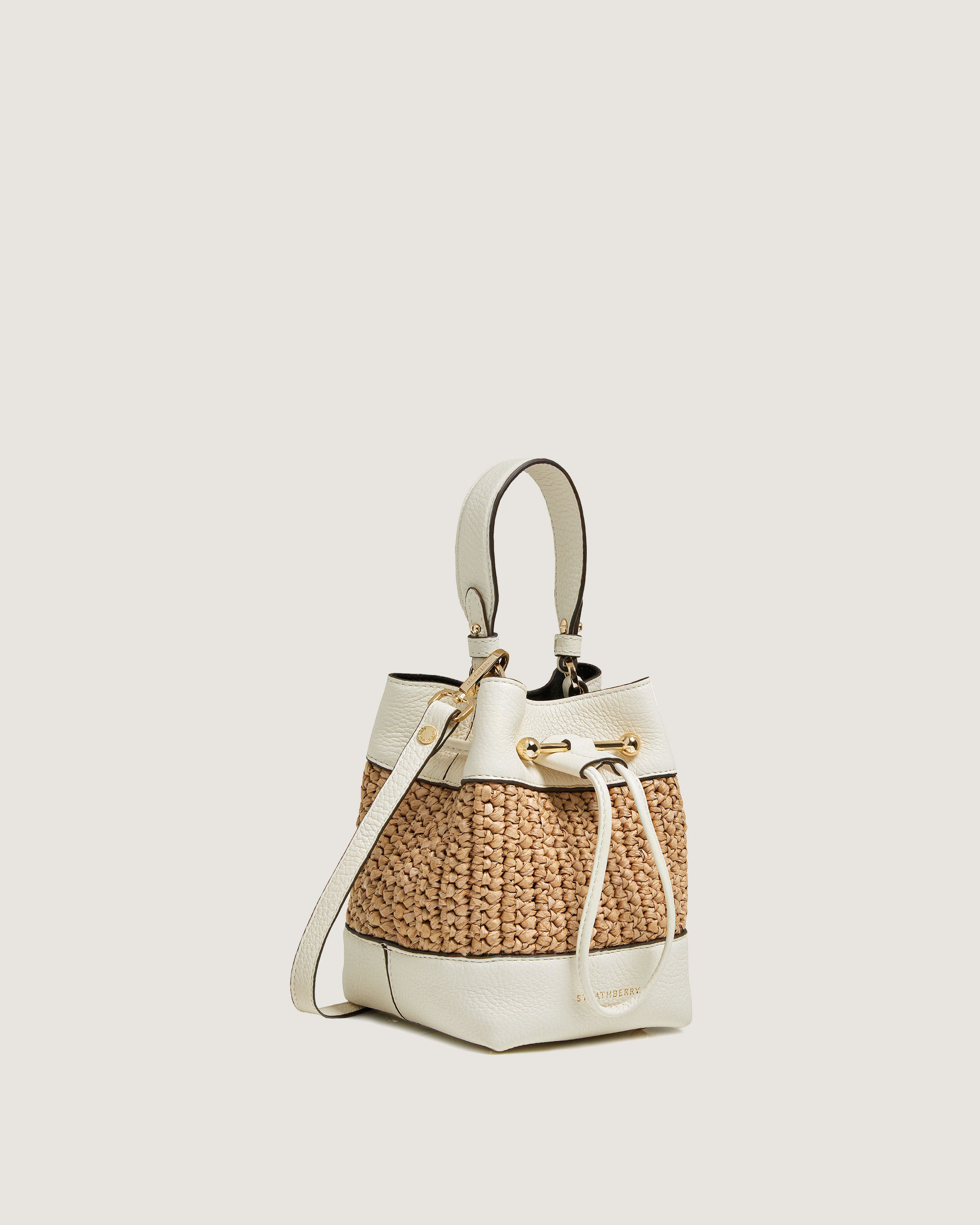 A white handbag with a handle on a white background