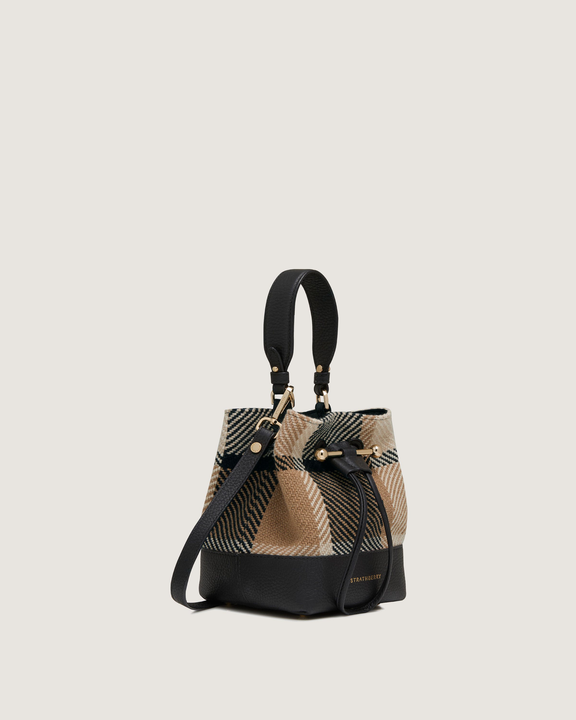 A brown and black handbag with a black strap