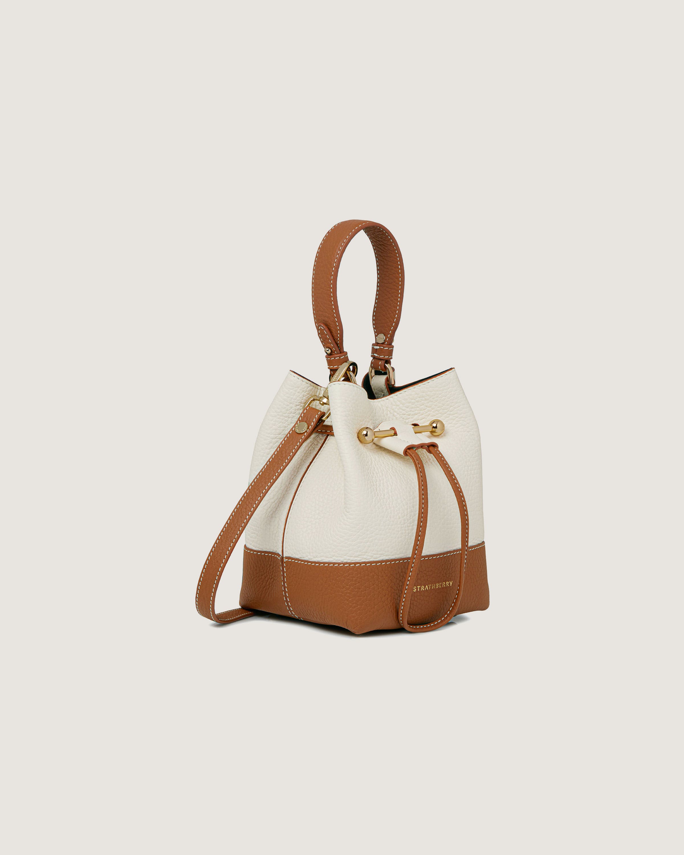 A white and brown handbag on a white background