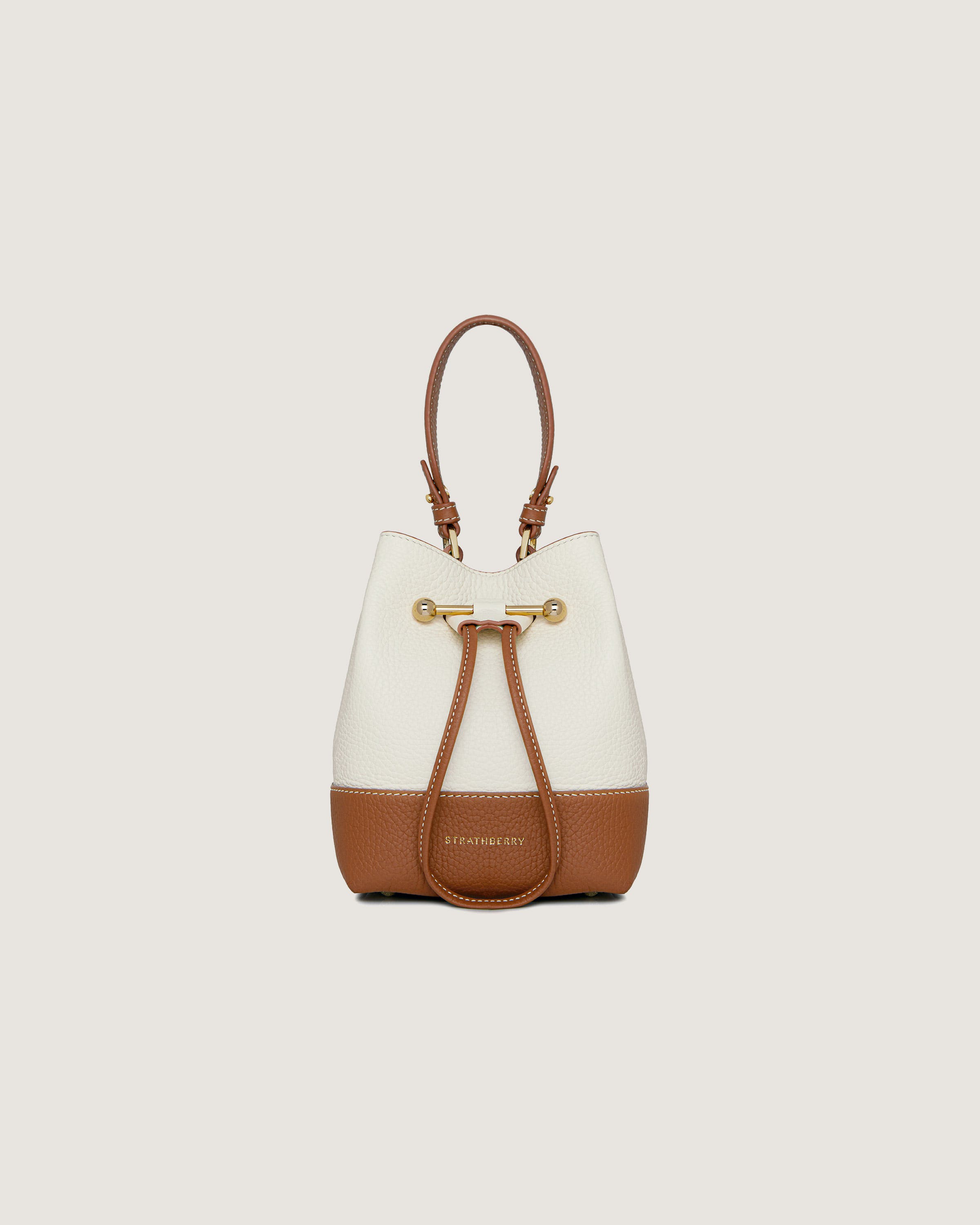 A white and brown handbag on a white background