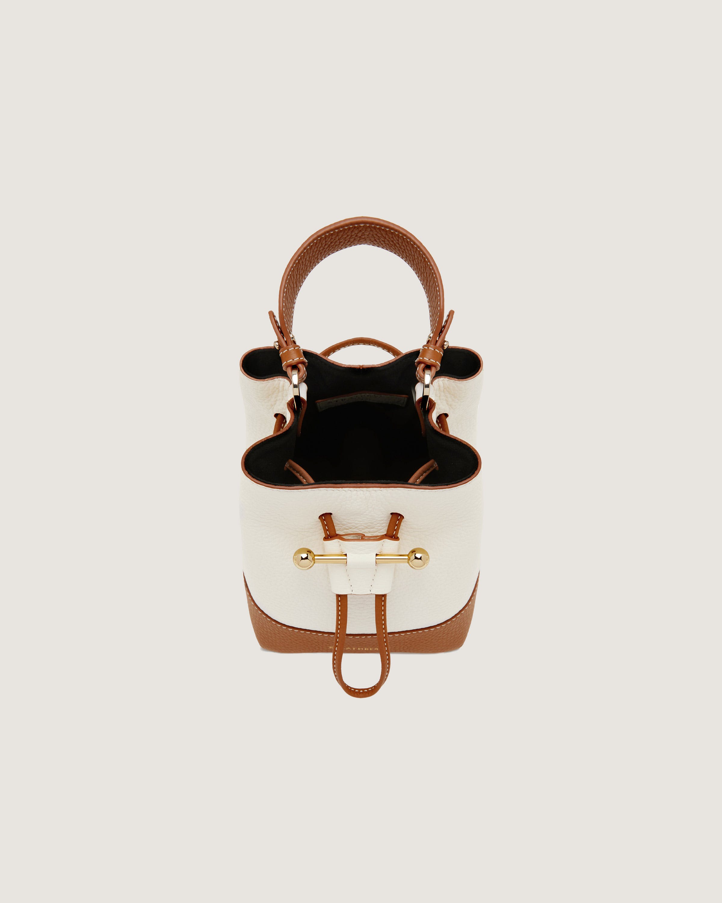 A white and brown handbag with a brown handle