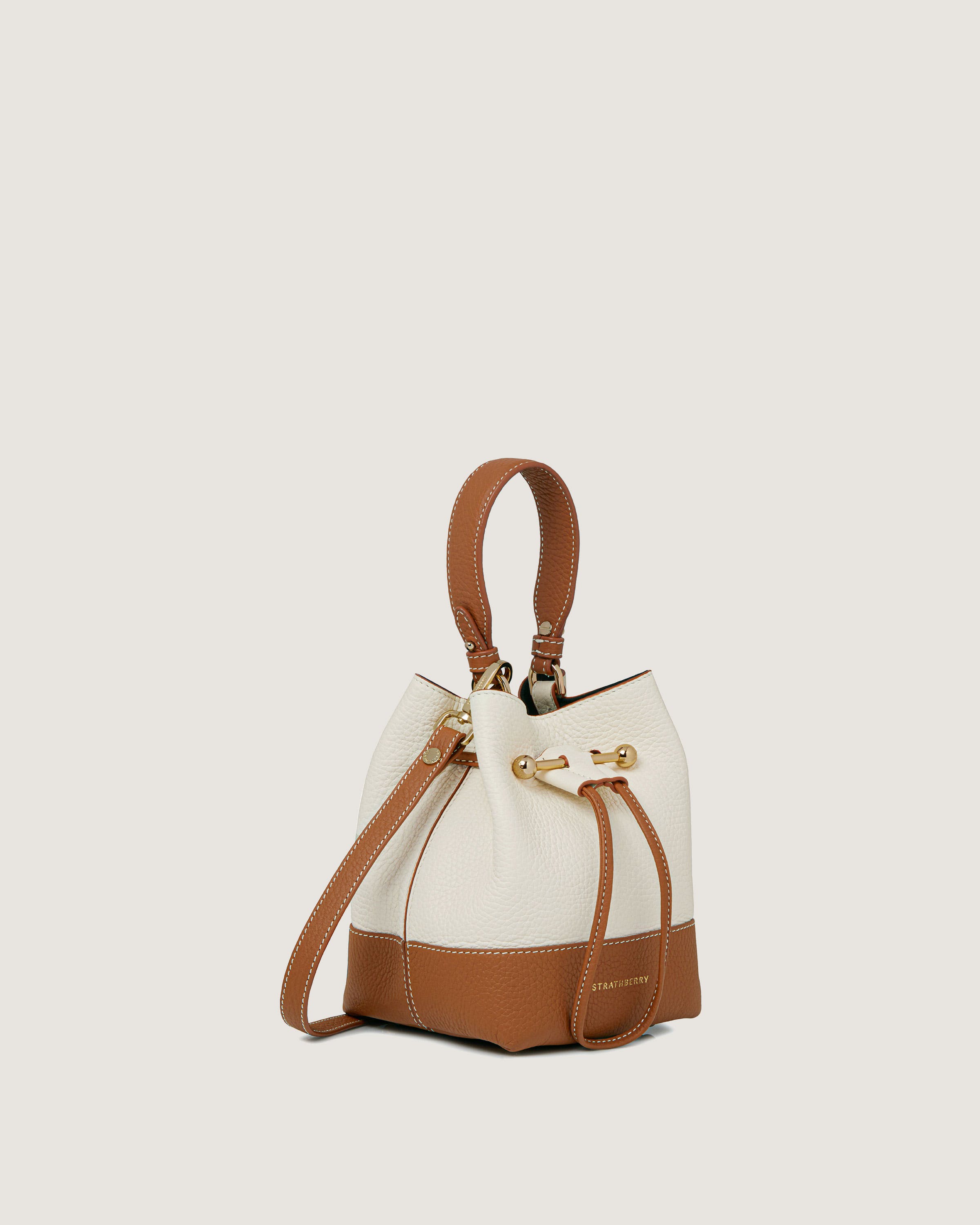 A white and brown handbag on a white background