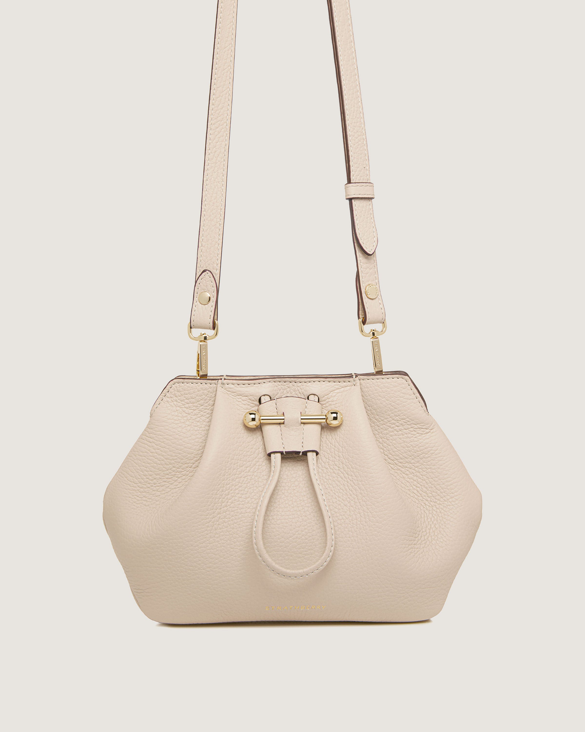 A white handbag with a handle on a white background