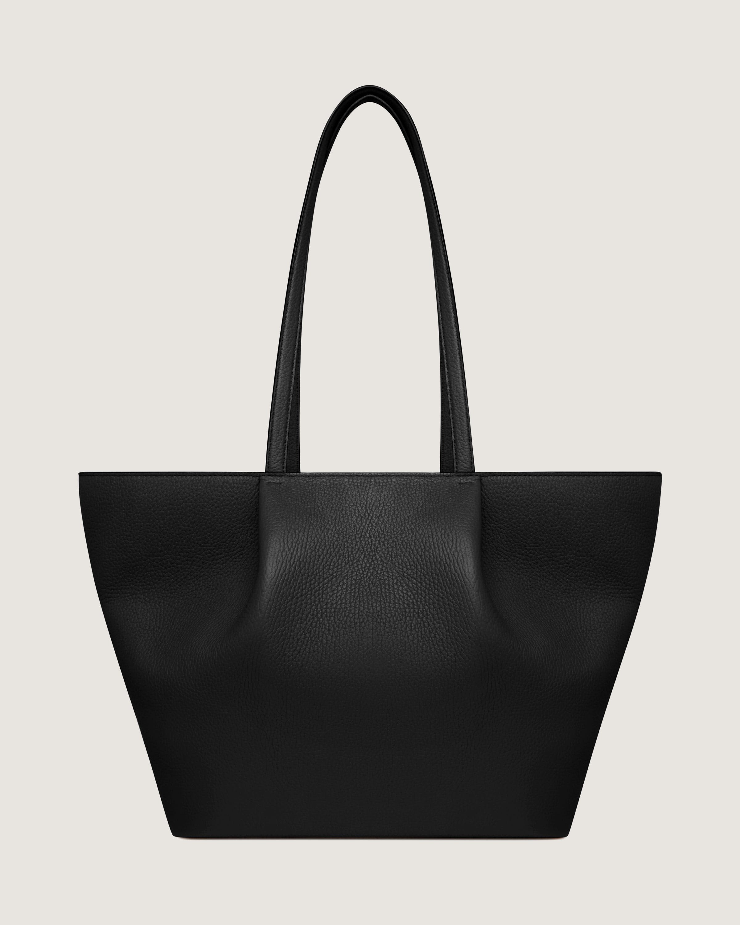 A black leather tote bag on a white background