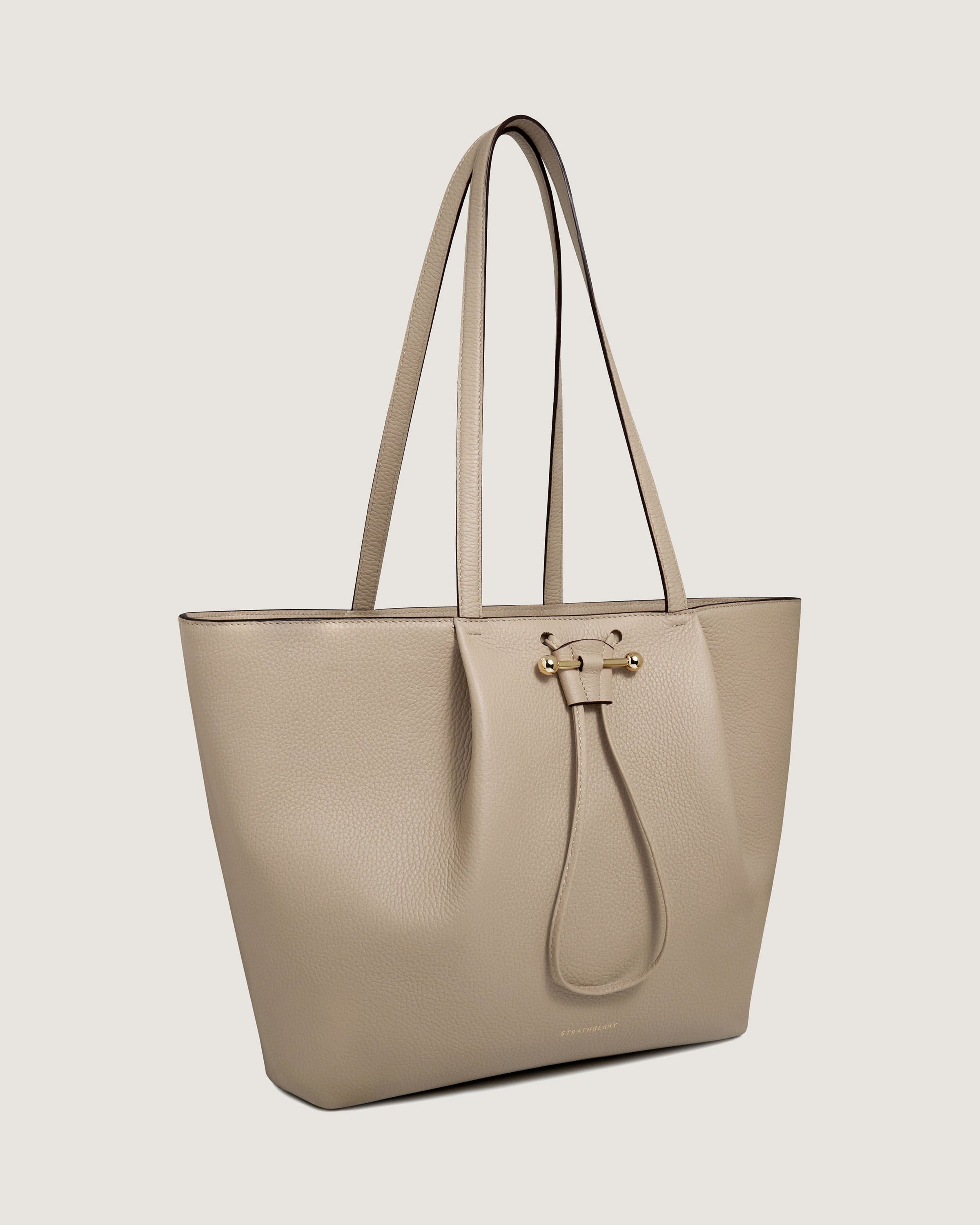 A beige tote bag on a white background