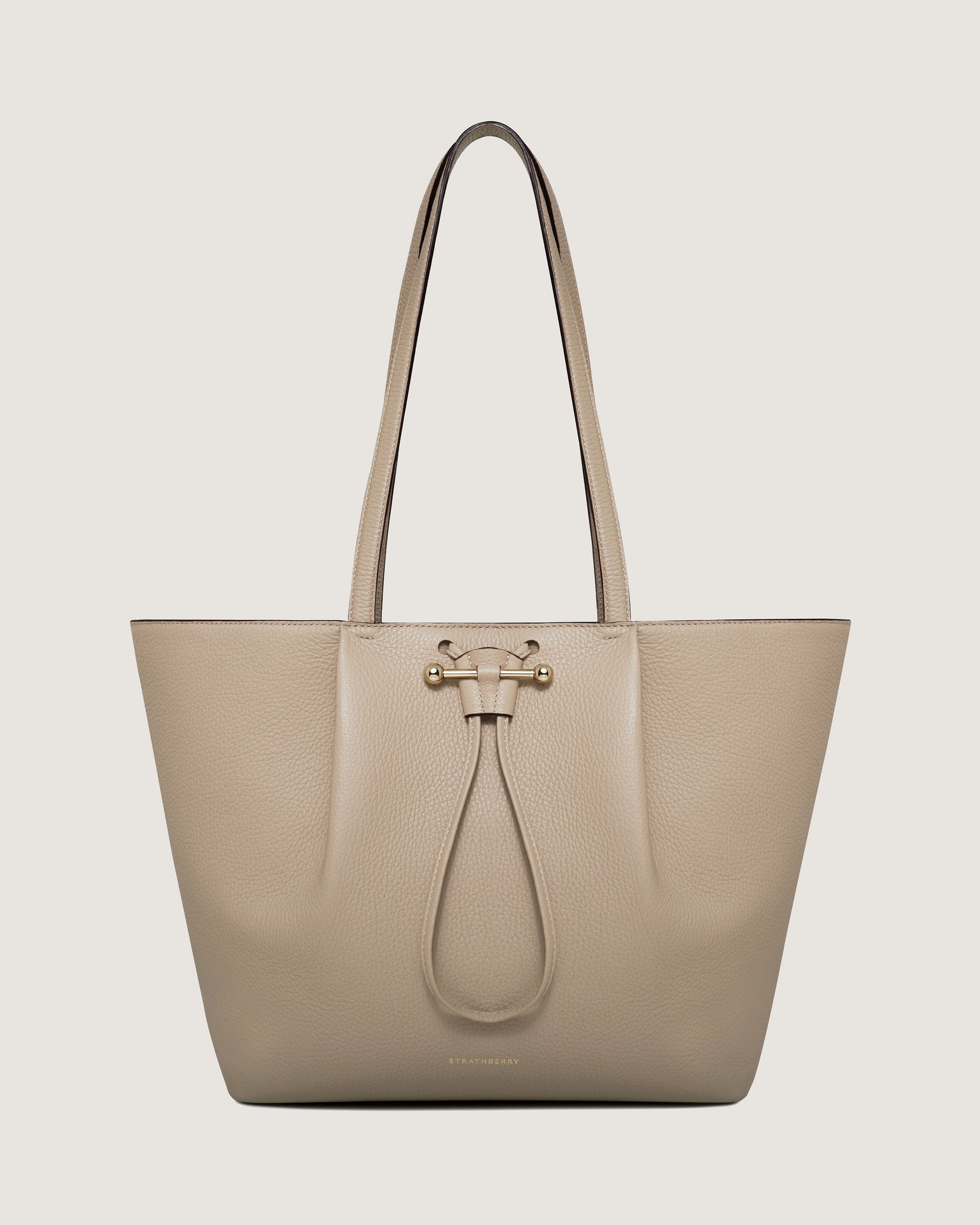 A beige leather handbag with a long handle