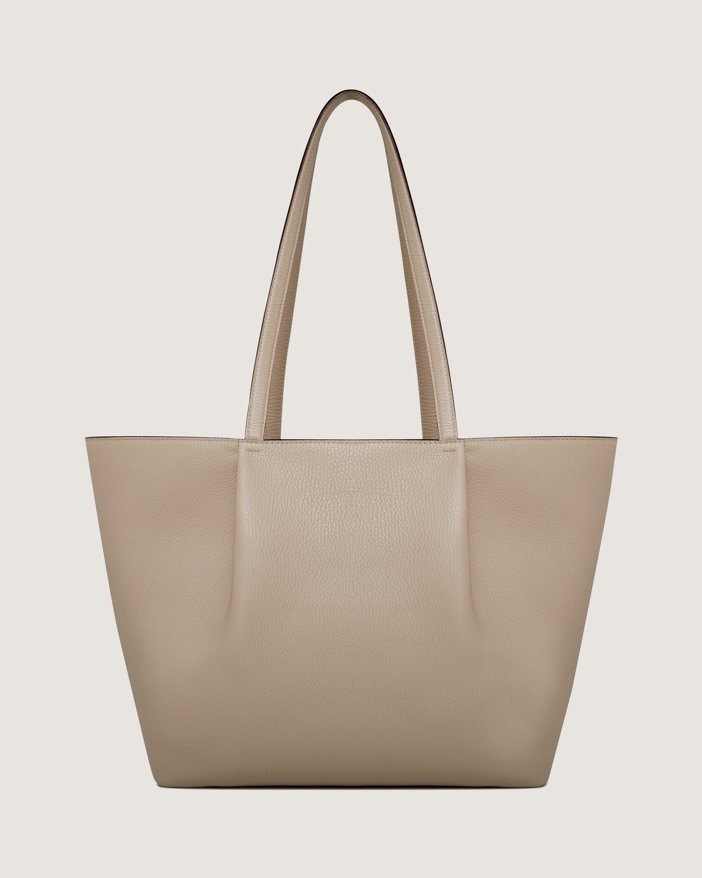 A beige tote bag on a white background