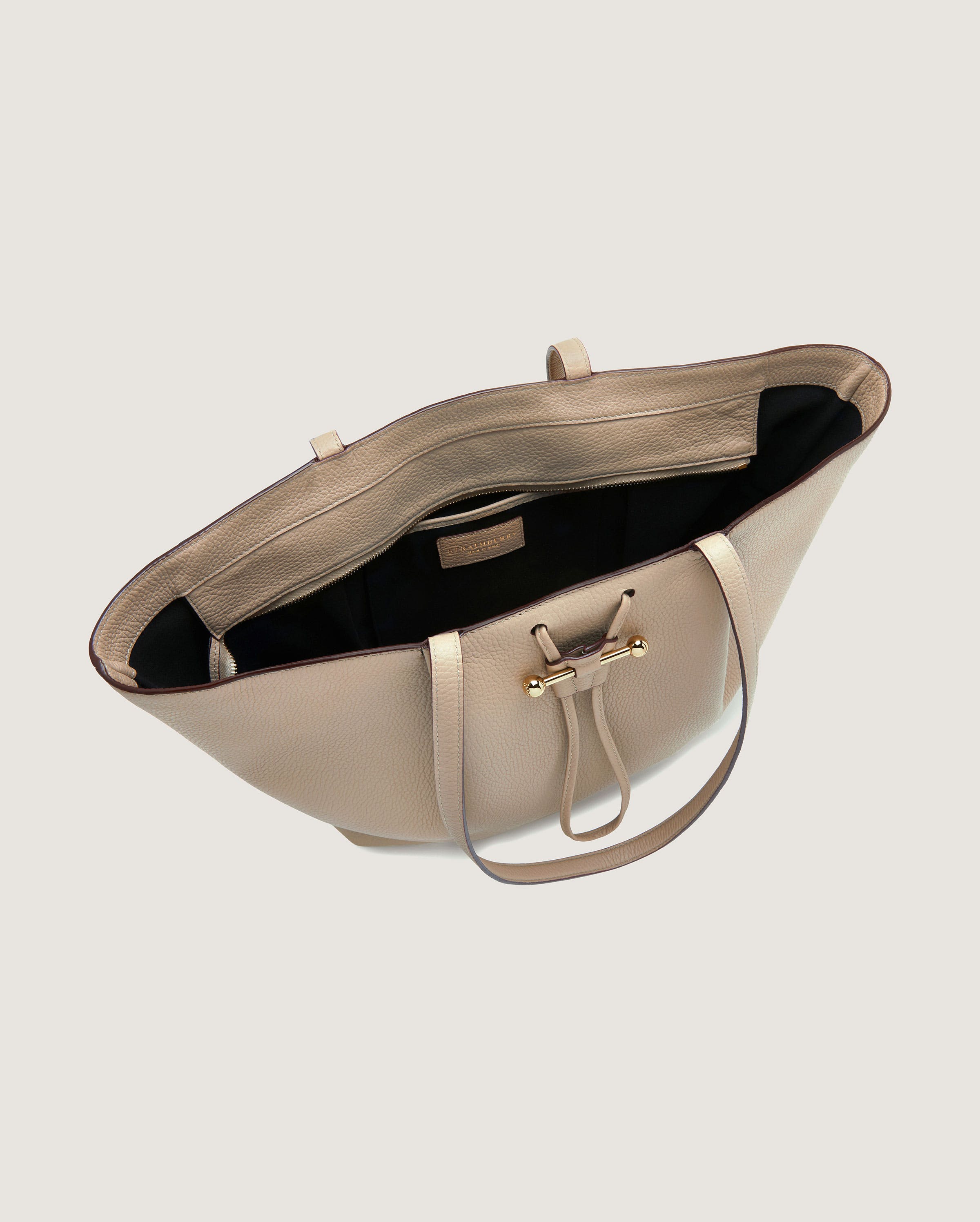 A white purse with a black handle