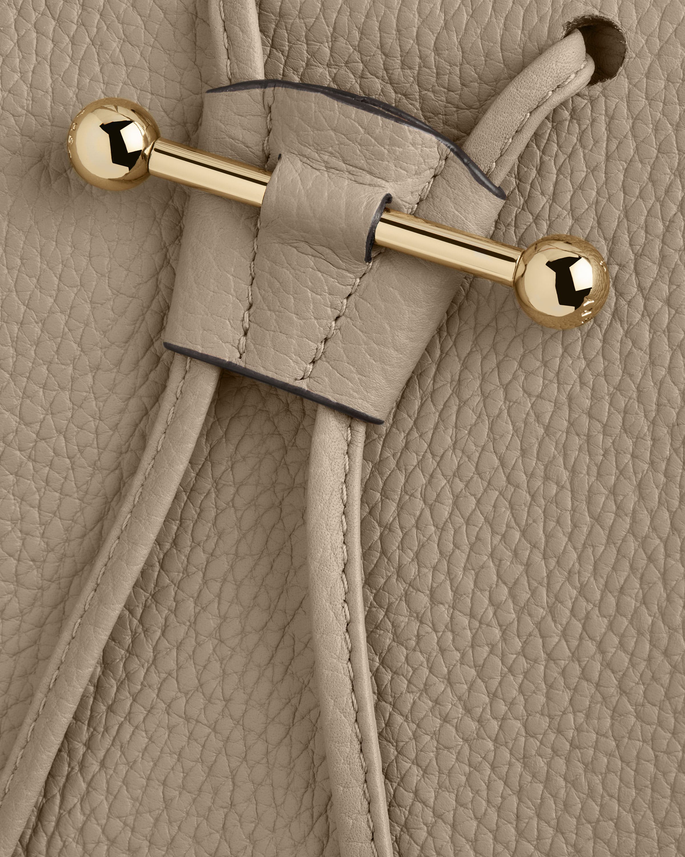 A close up of the handle of a purse