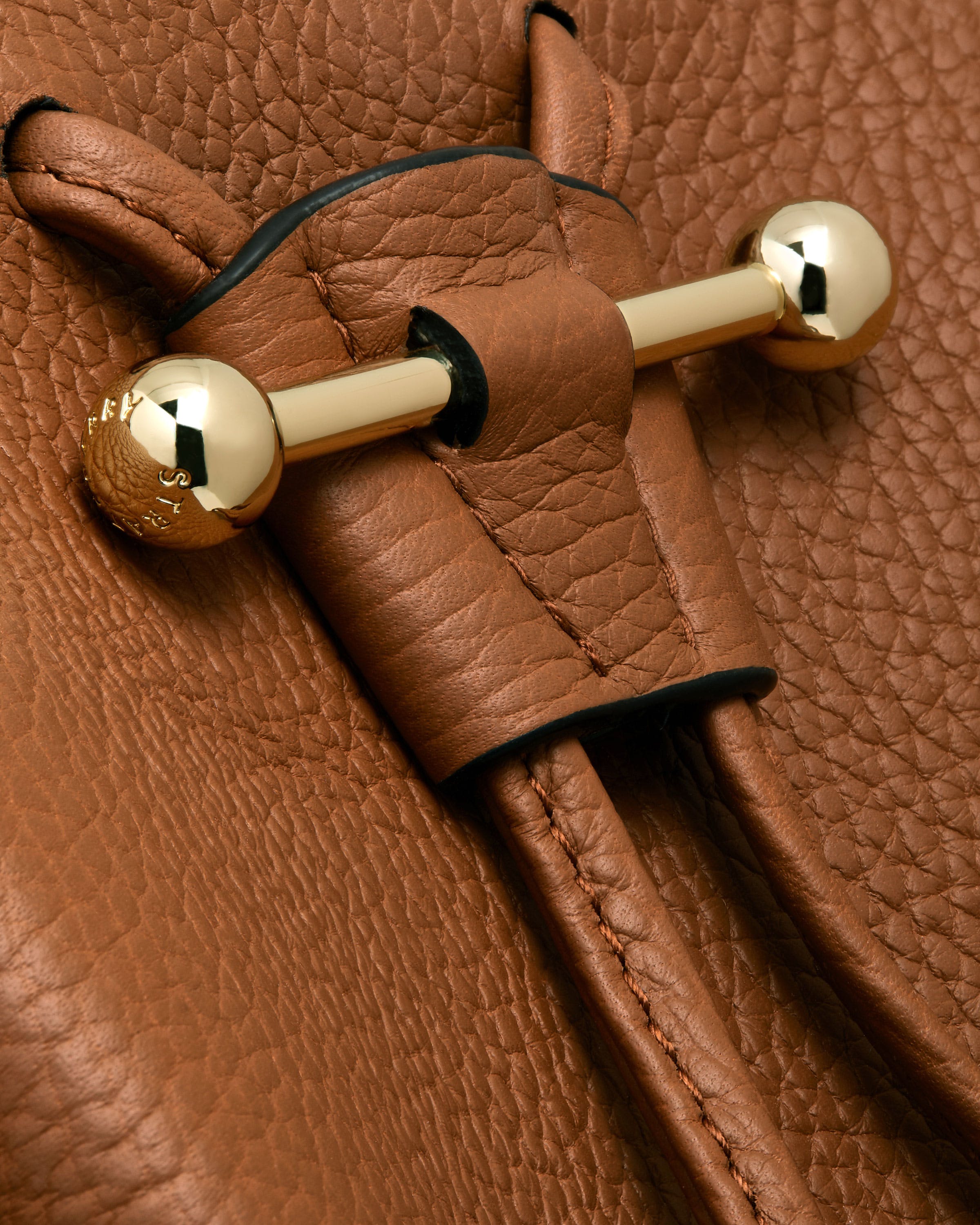 A close up of a brown purse with a handle