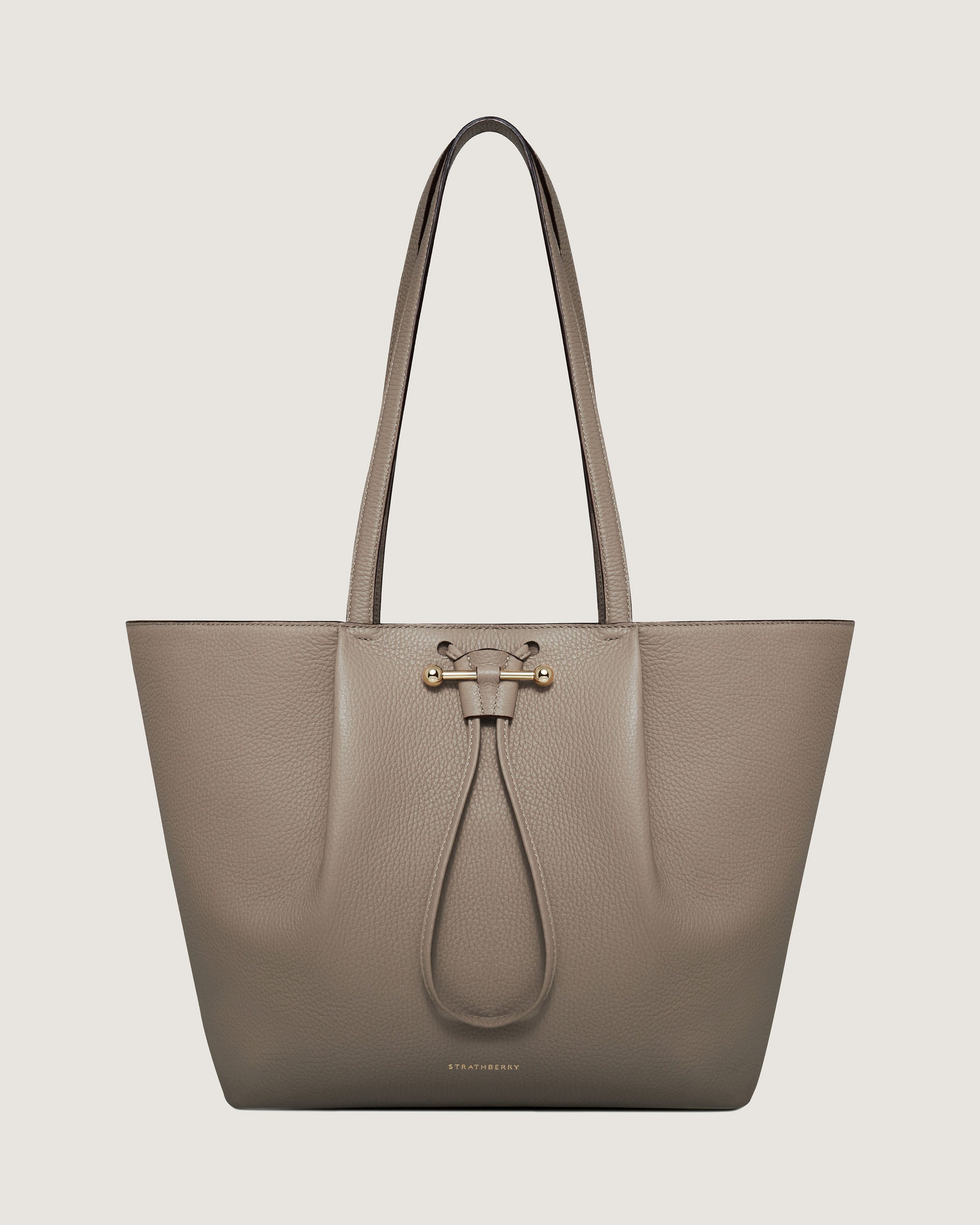 A grey leather tote bag with a long handle