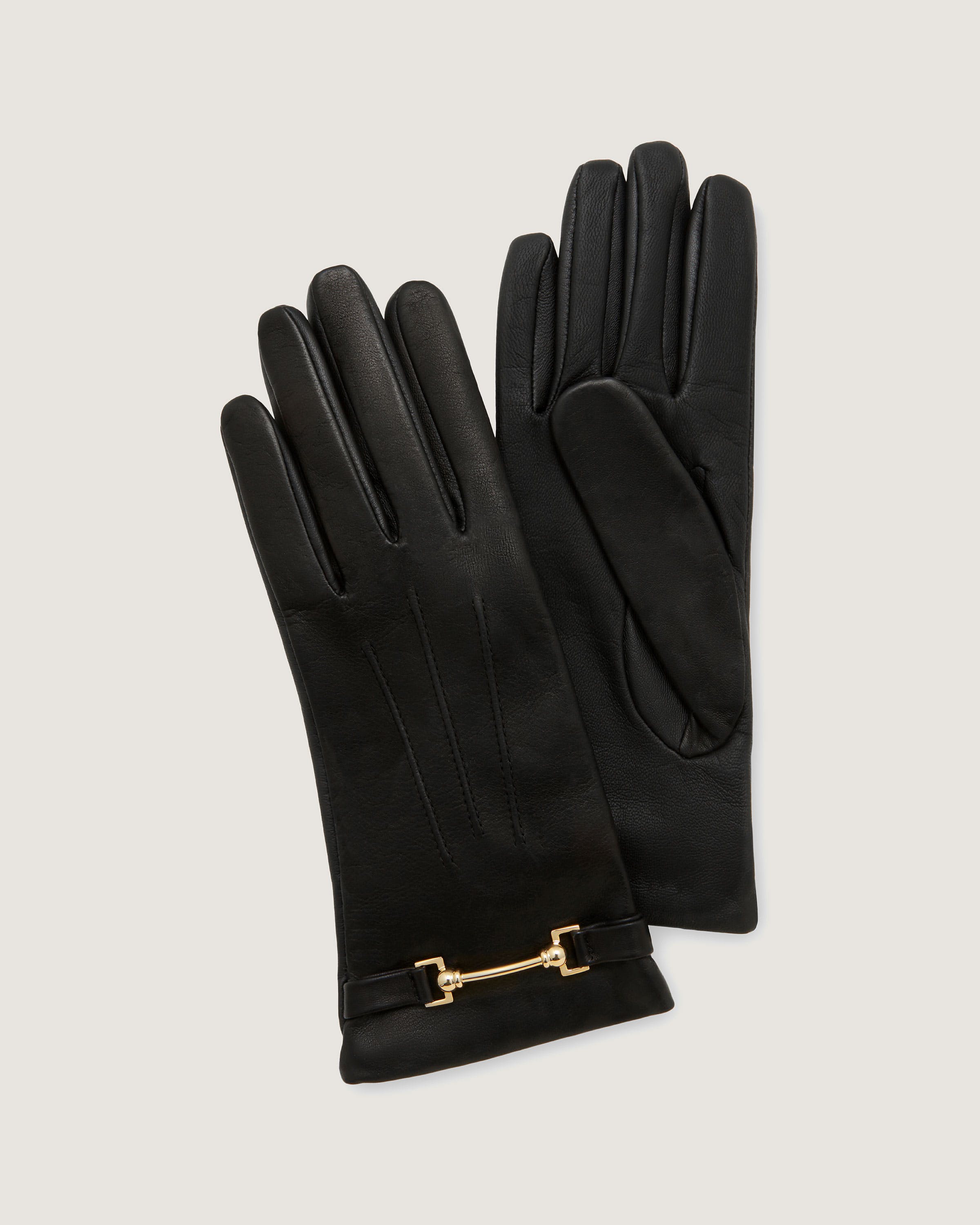 A pair of black leather gloves with a gold chain