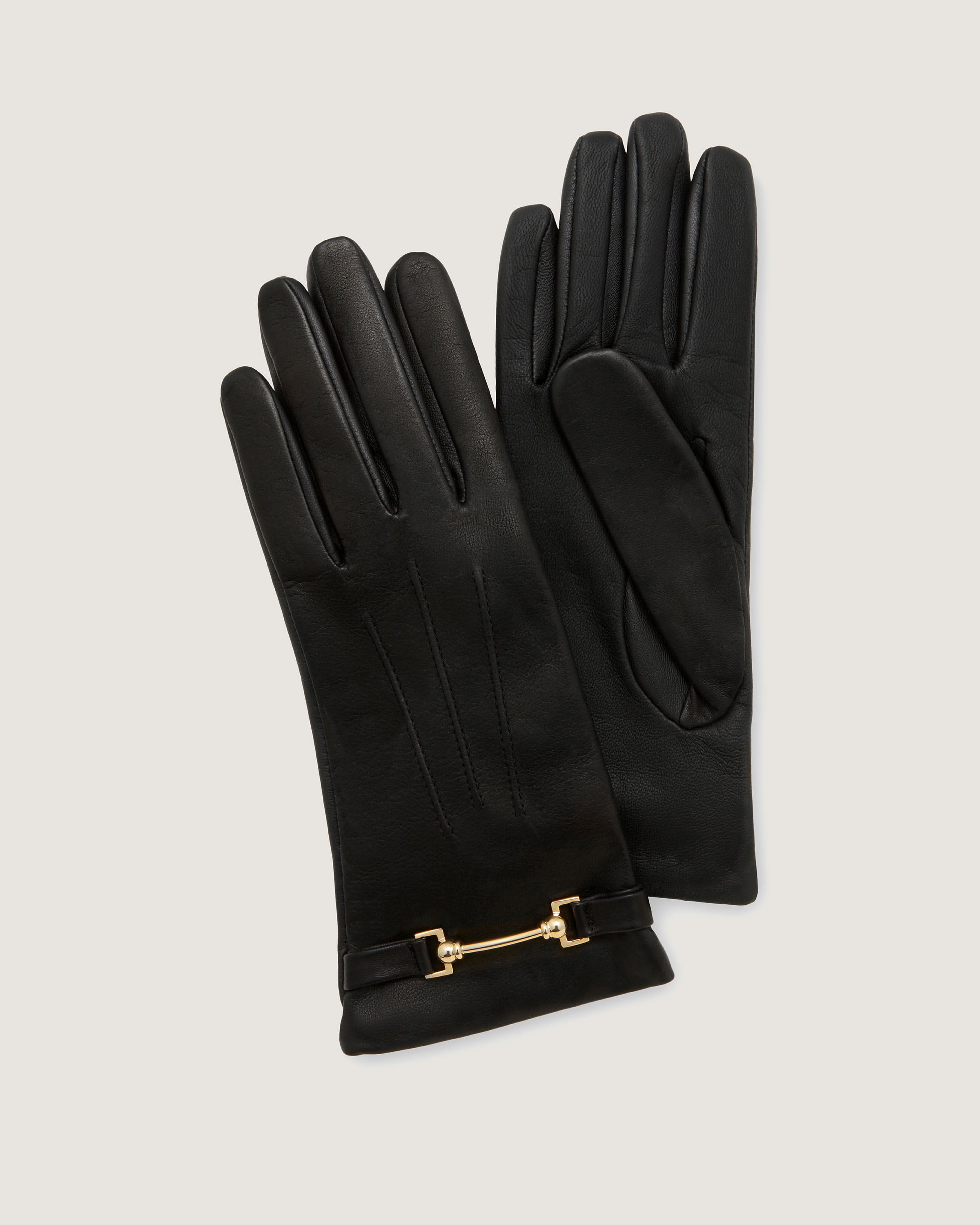 A pair of black gloves with a gold chain