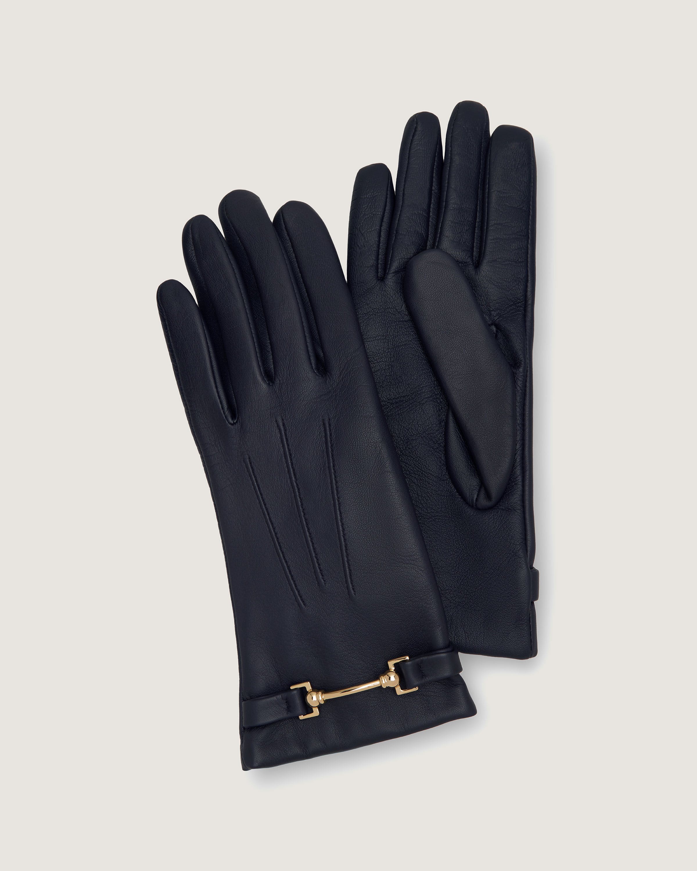 A pair of black leather gloves with a gold chain