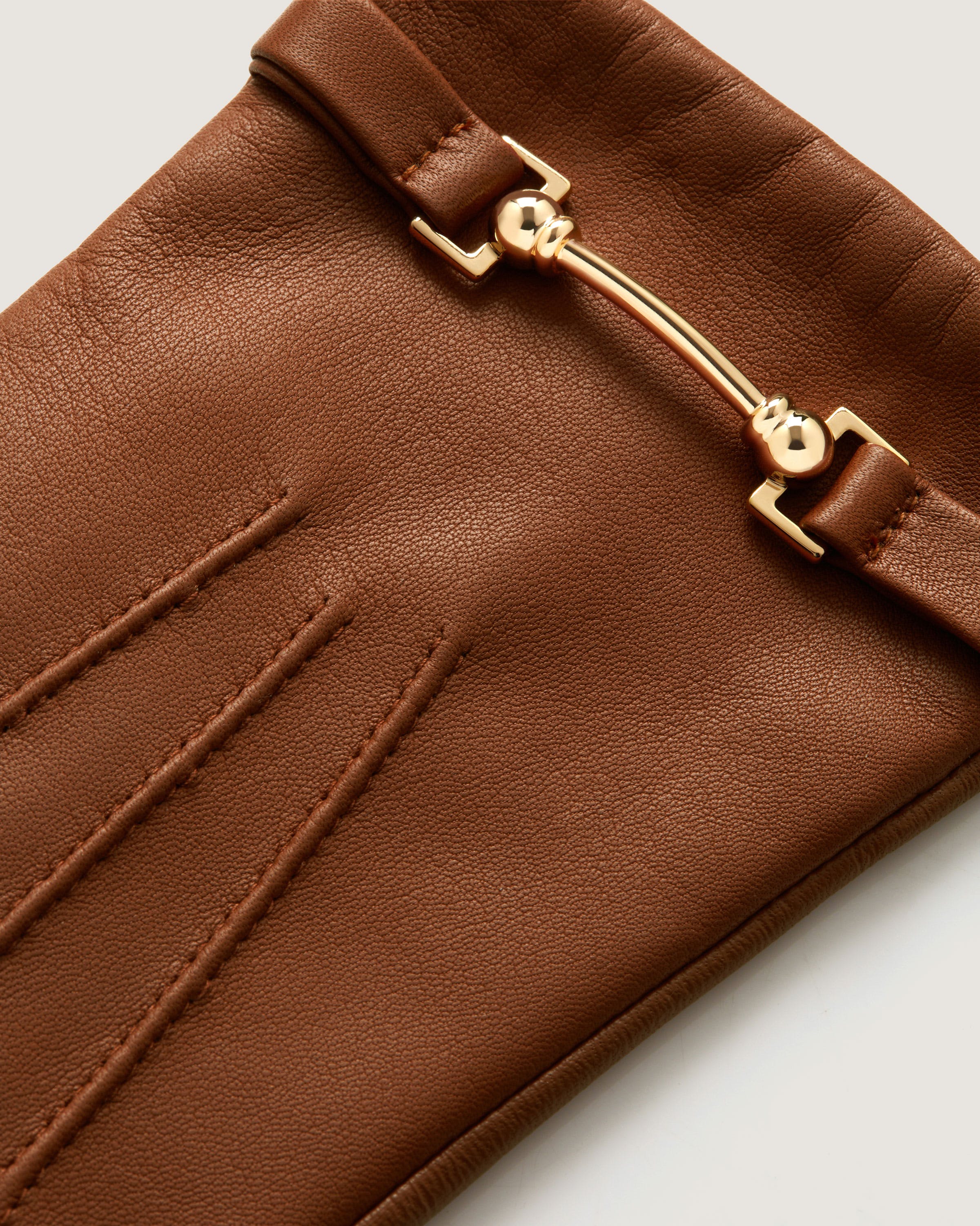 A close up of a brown purse with a zipper