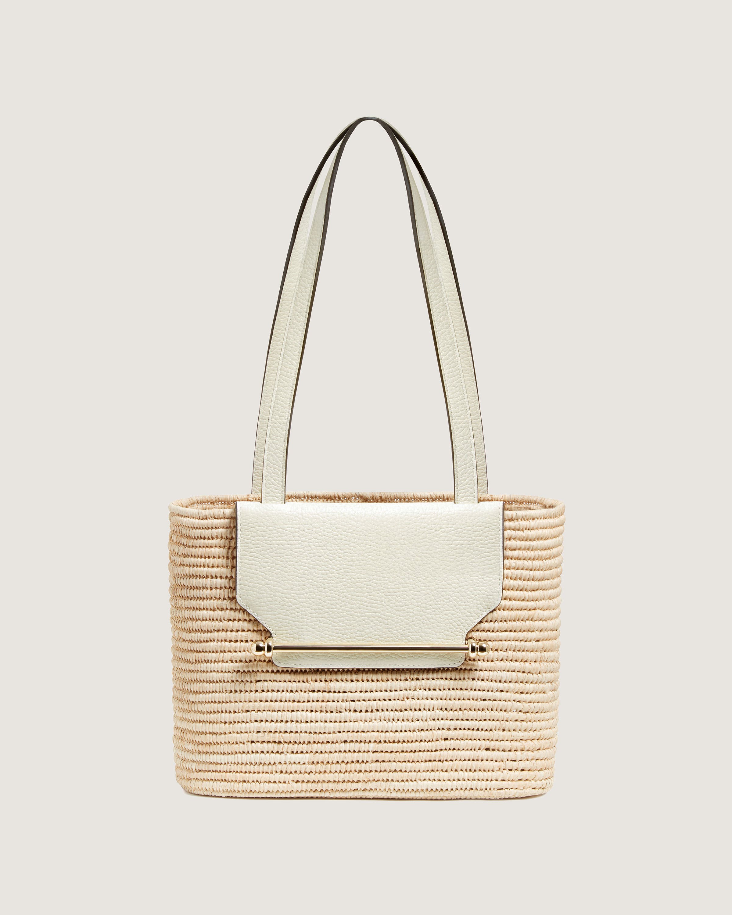 A handbag with a white handle and a beige strap