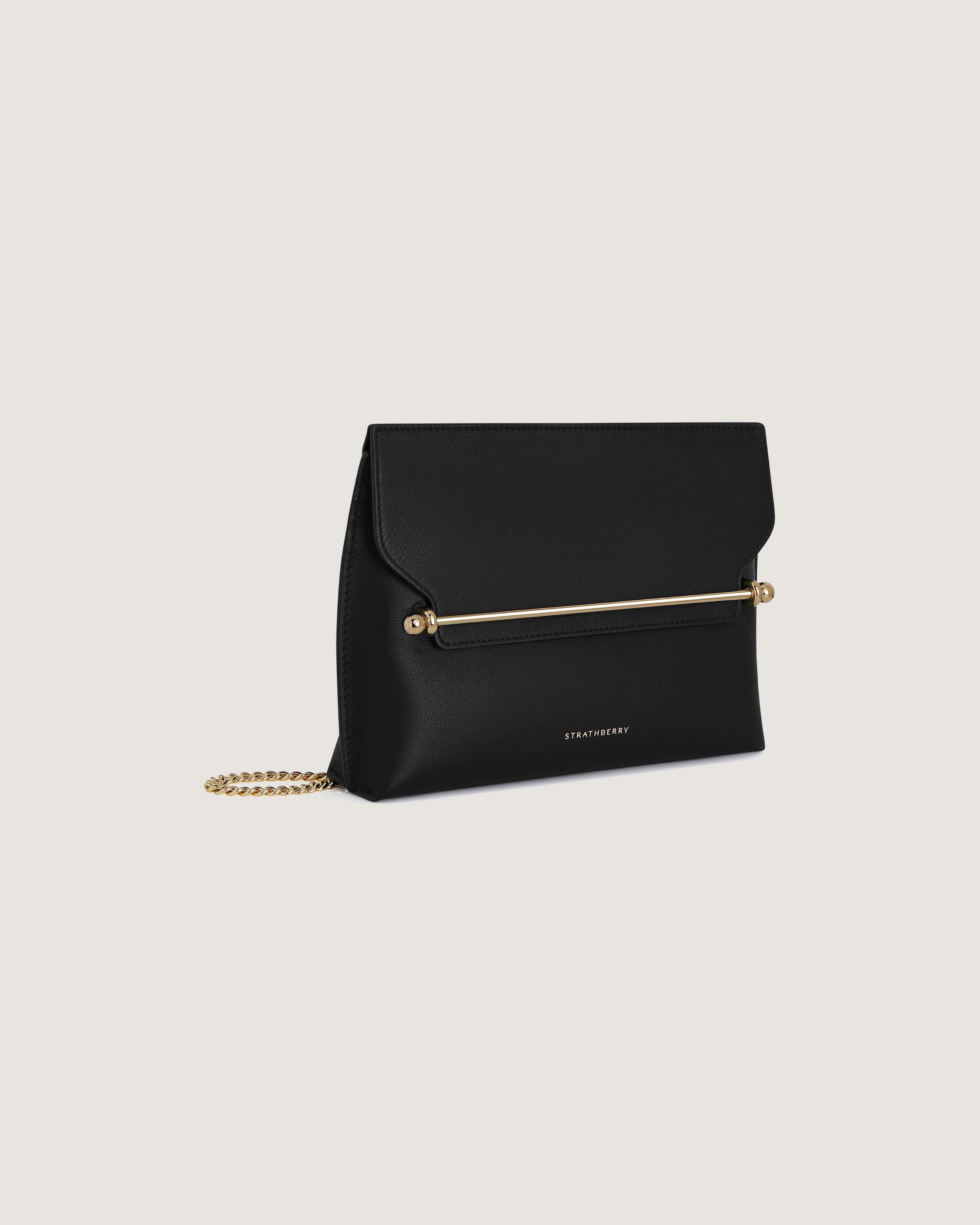 A black clutch bag with a gold chain