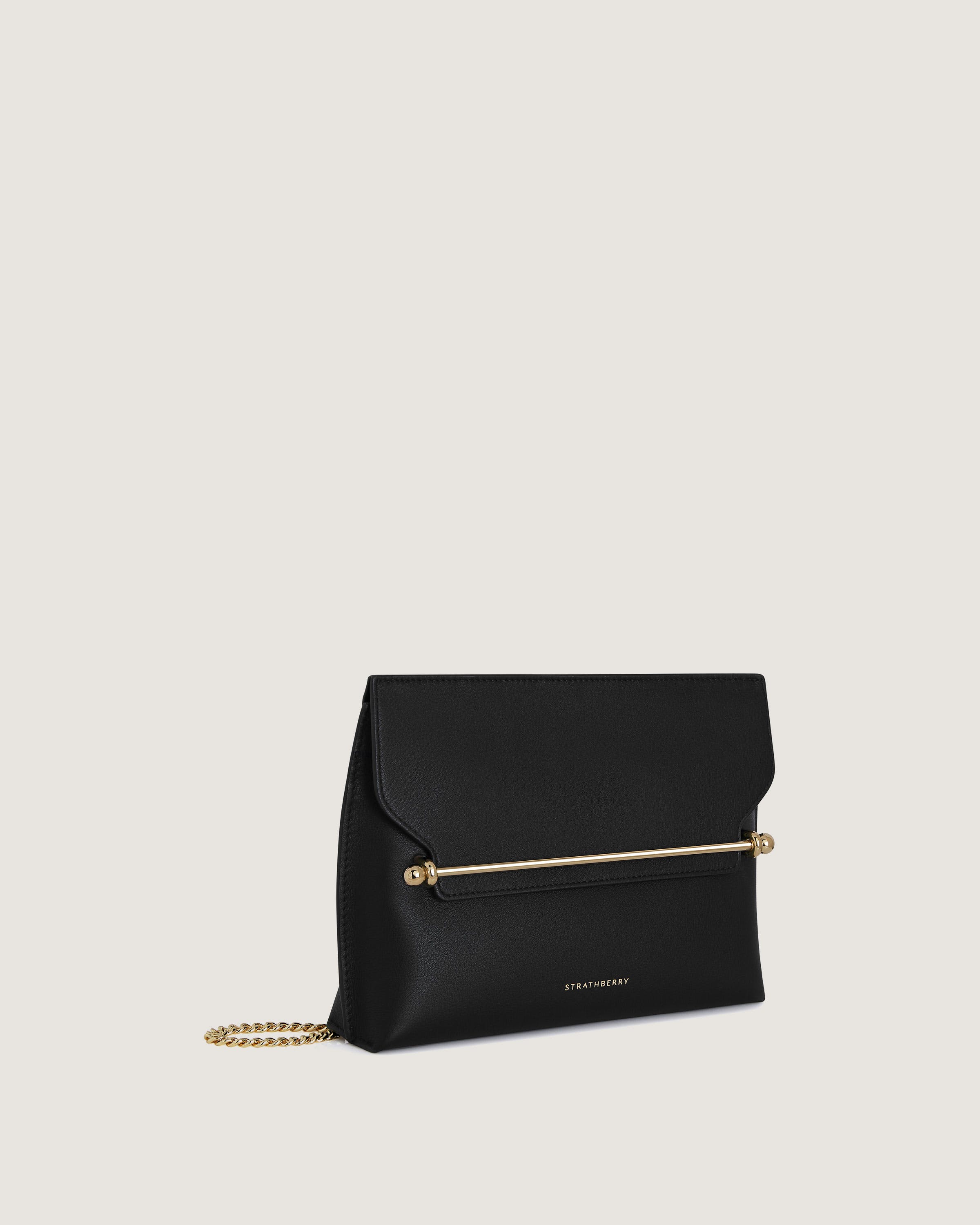 A black clutch bag with a gold chain