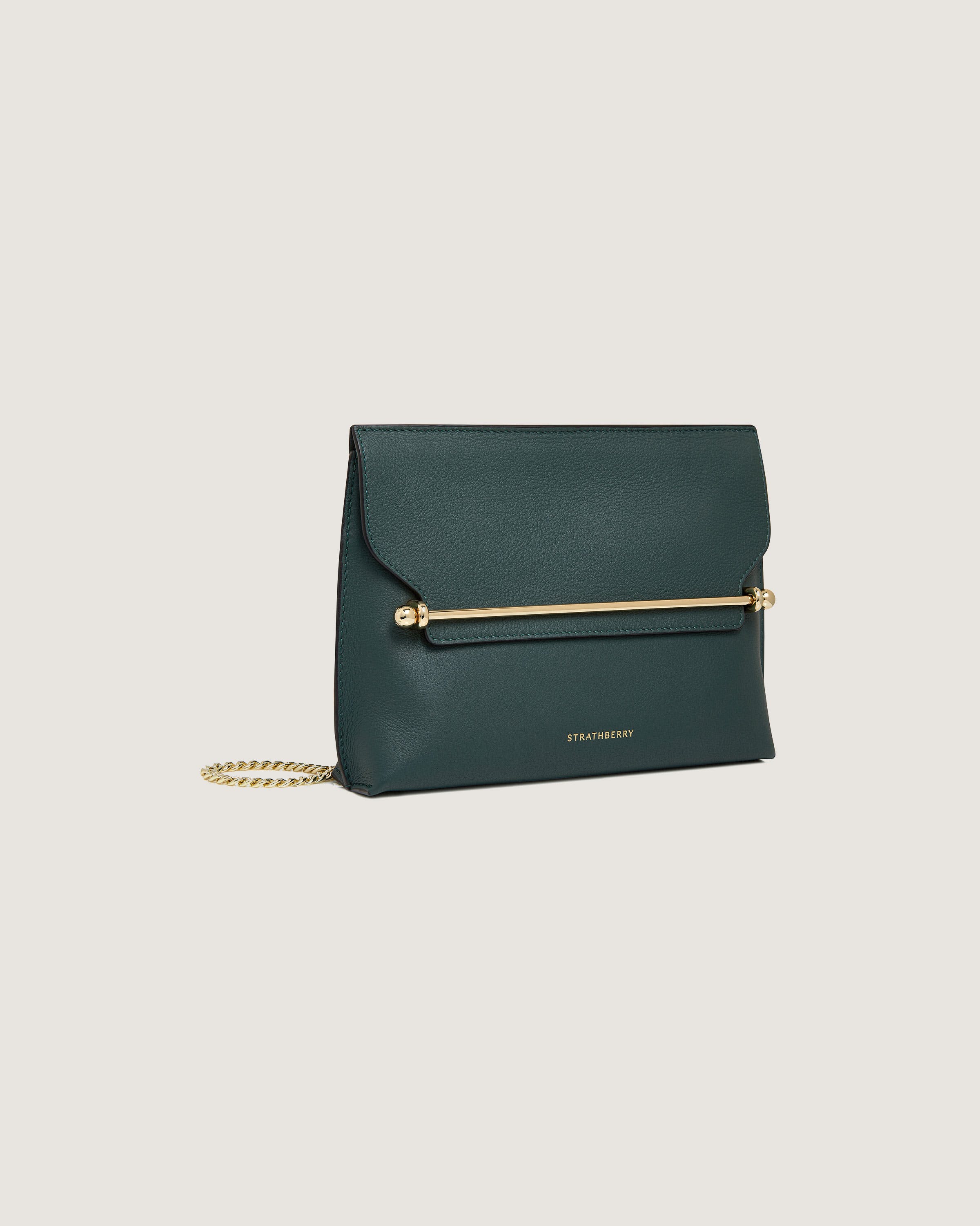 A green clutch bag with a gold chain