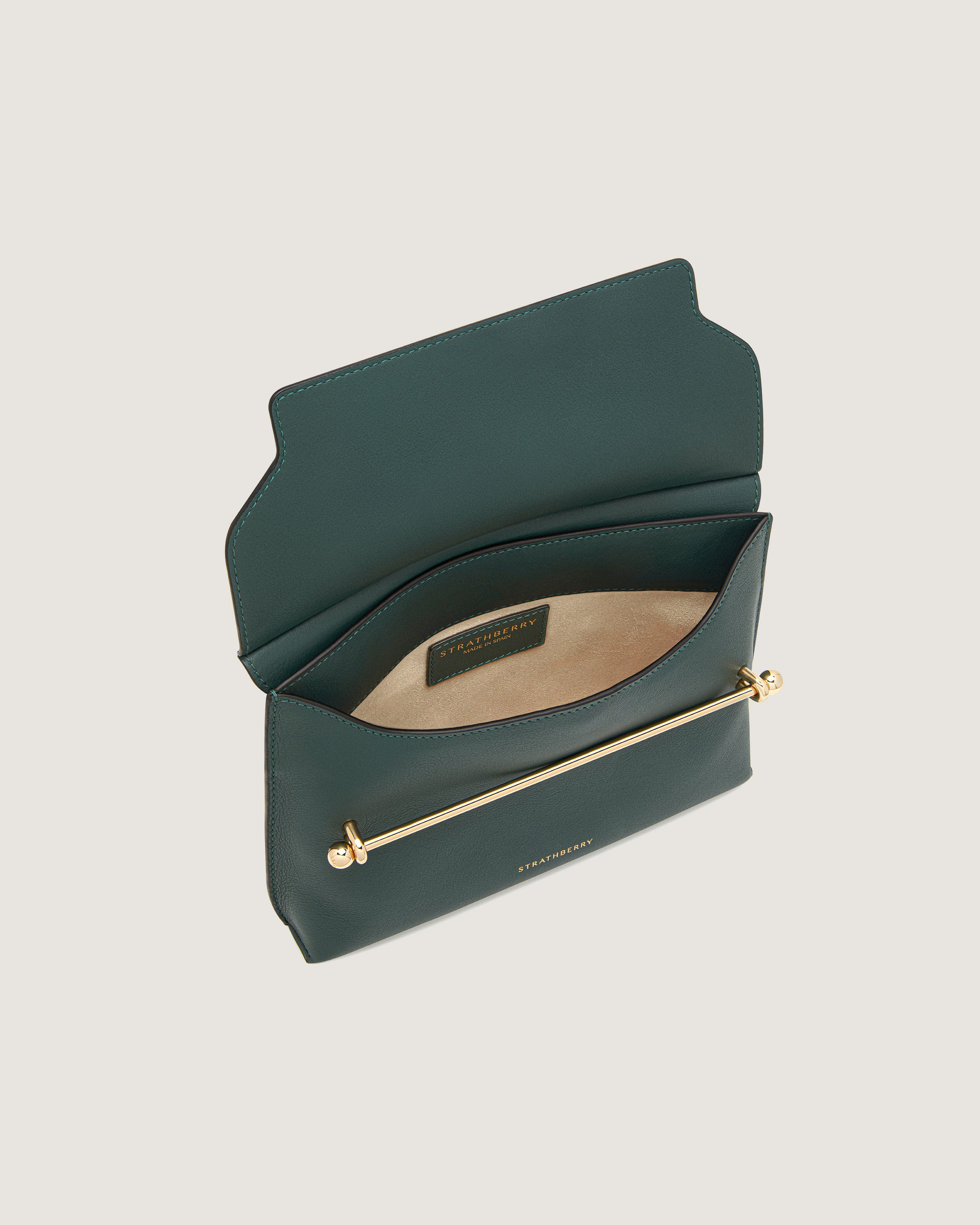 A green purse with a gold zipper