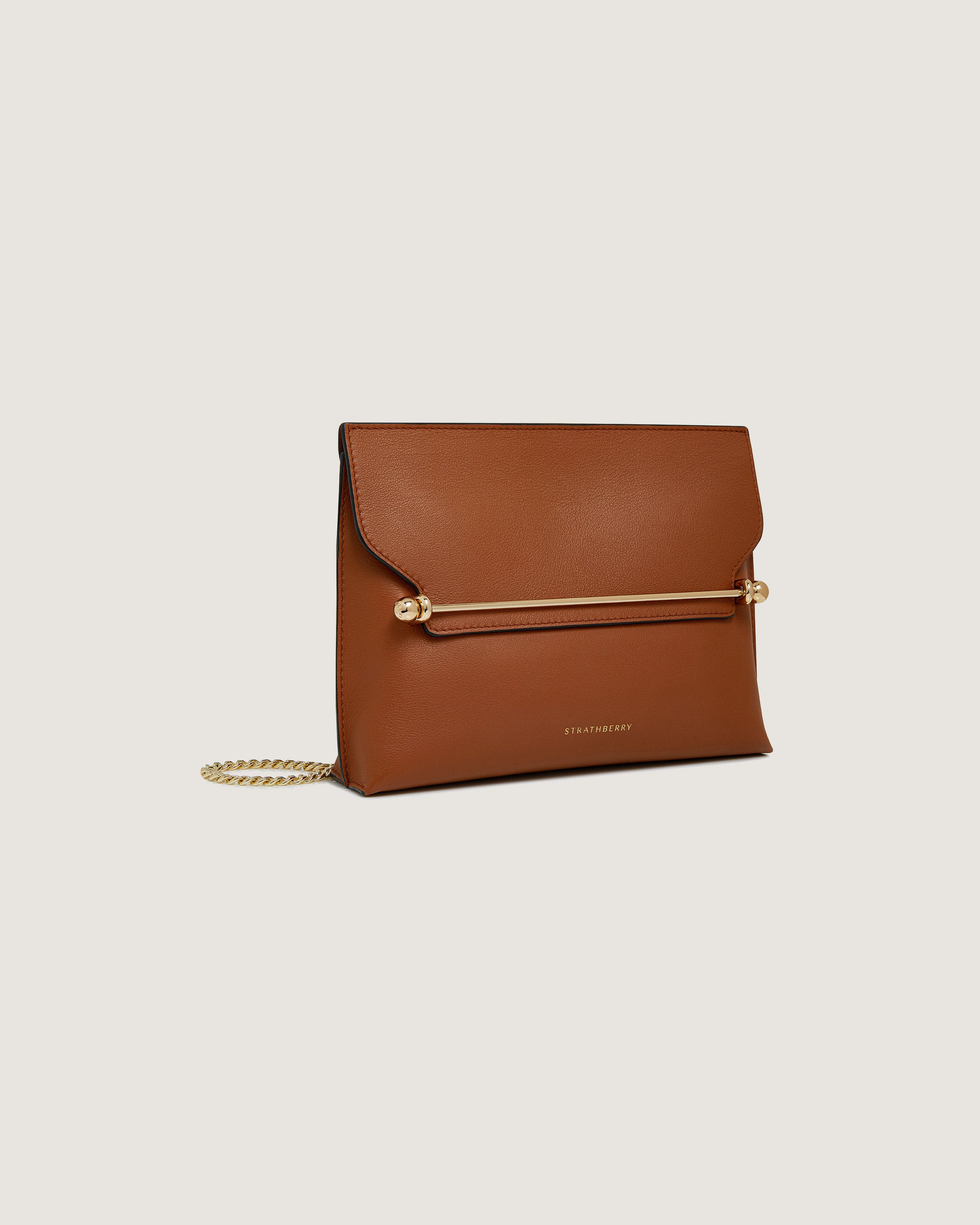 A brown leather clutch bag with a gold chain