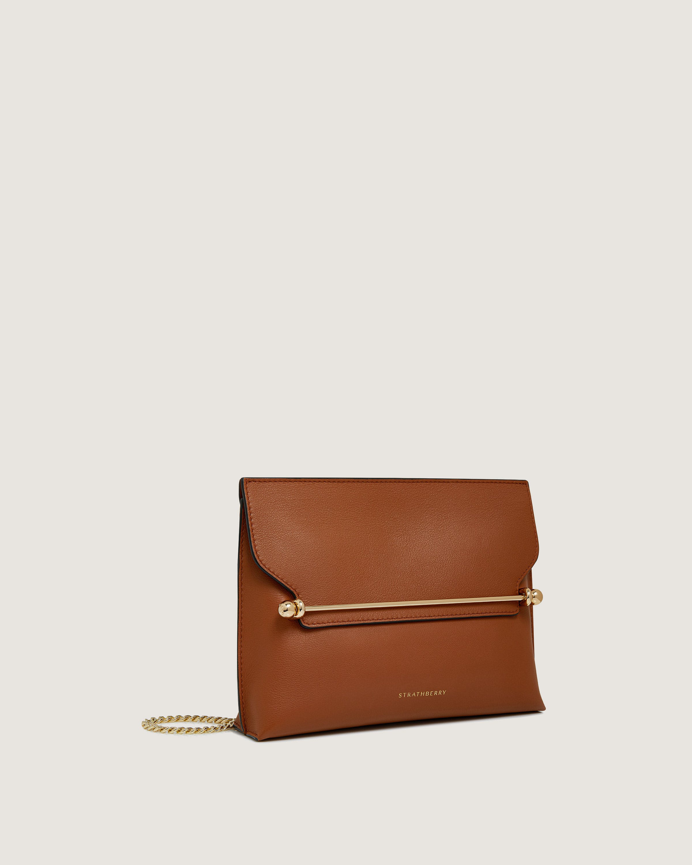 A brown leather clutch bag with a gold chain