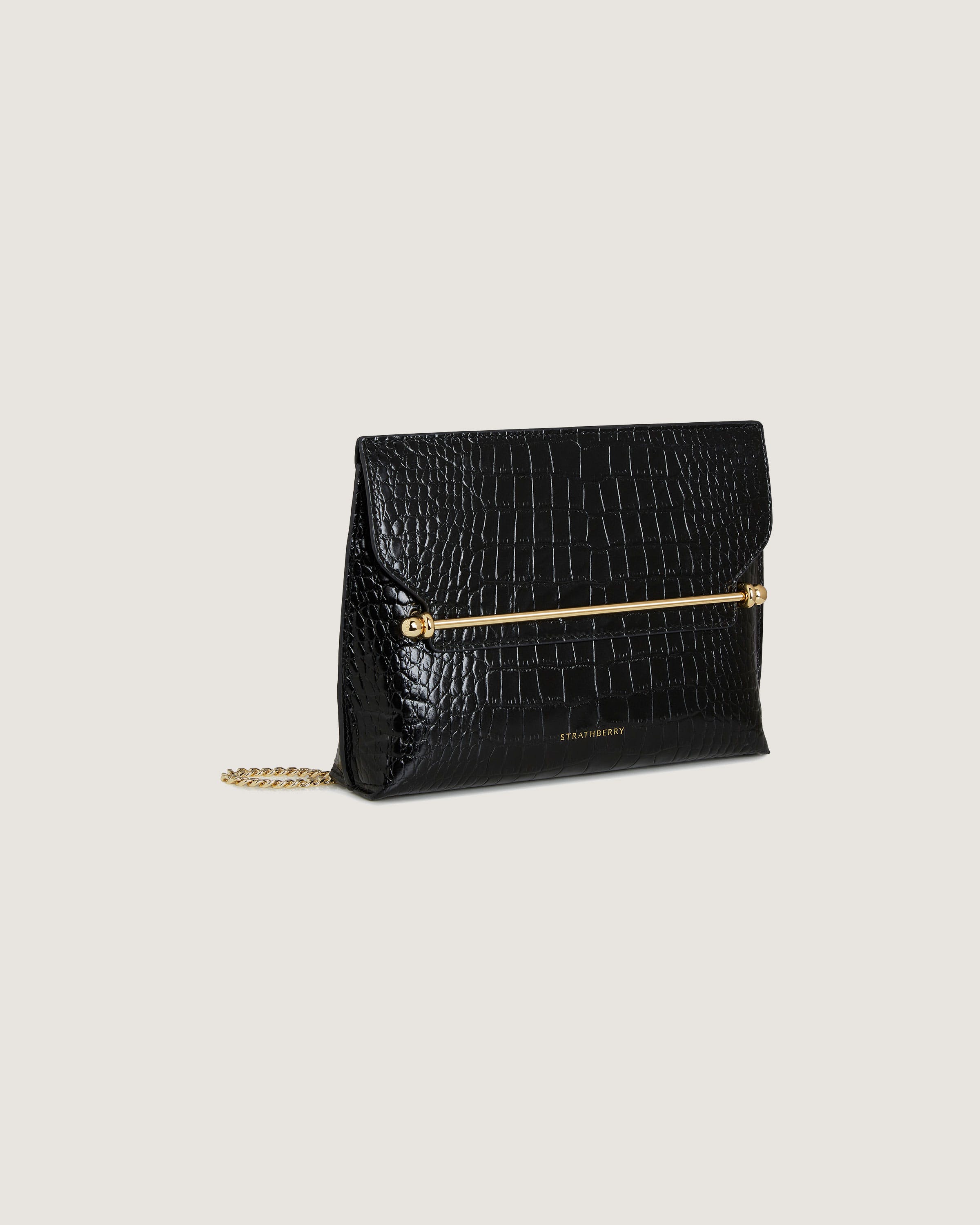 A black clutch bag with a gold chain