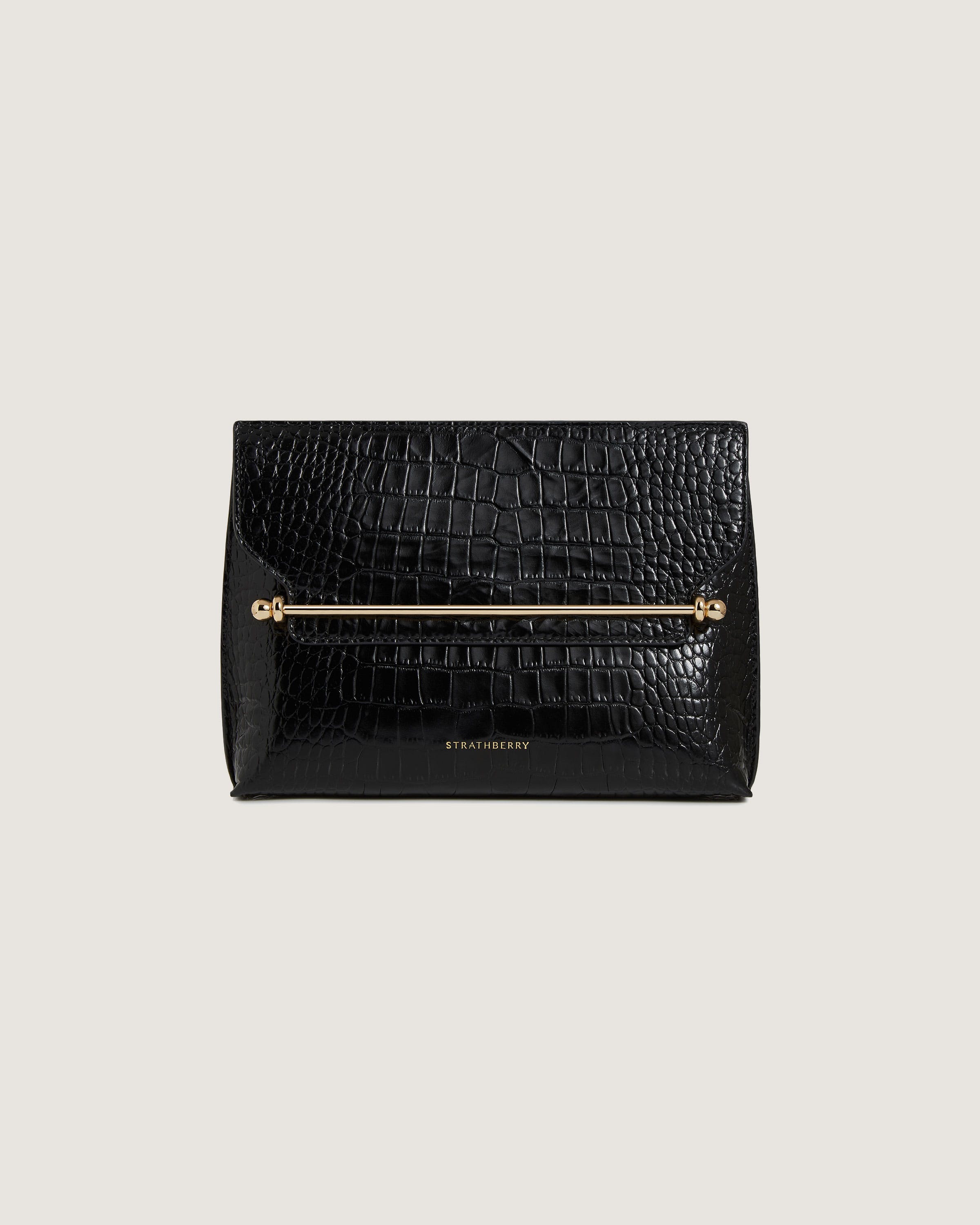 A black clutch bag with a gold handle