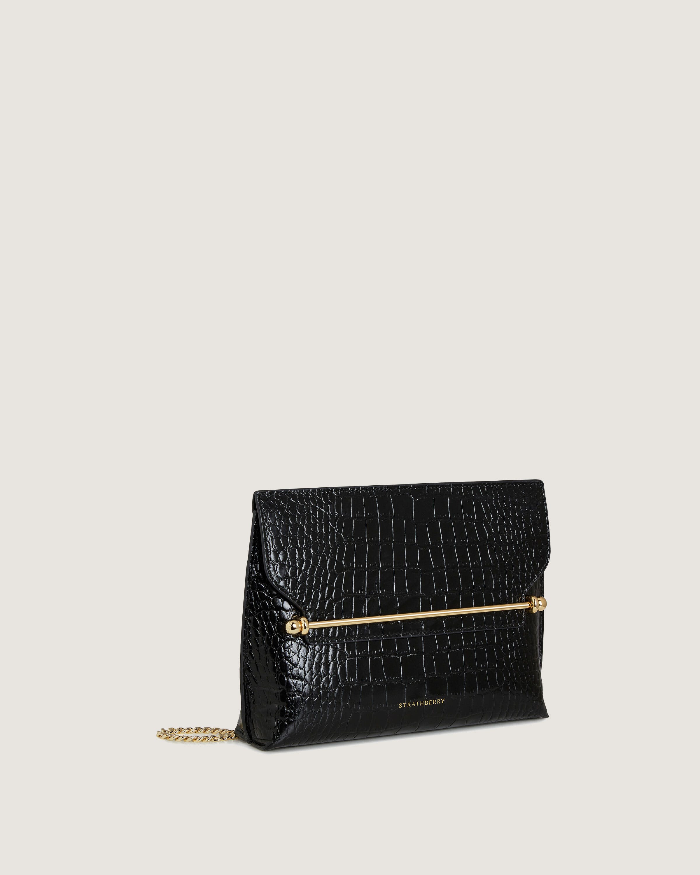 A black clutch bag with a gold chain