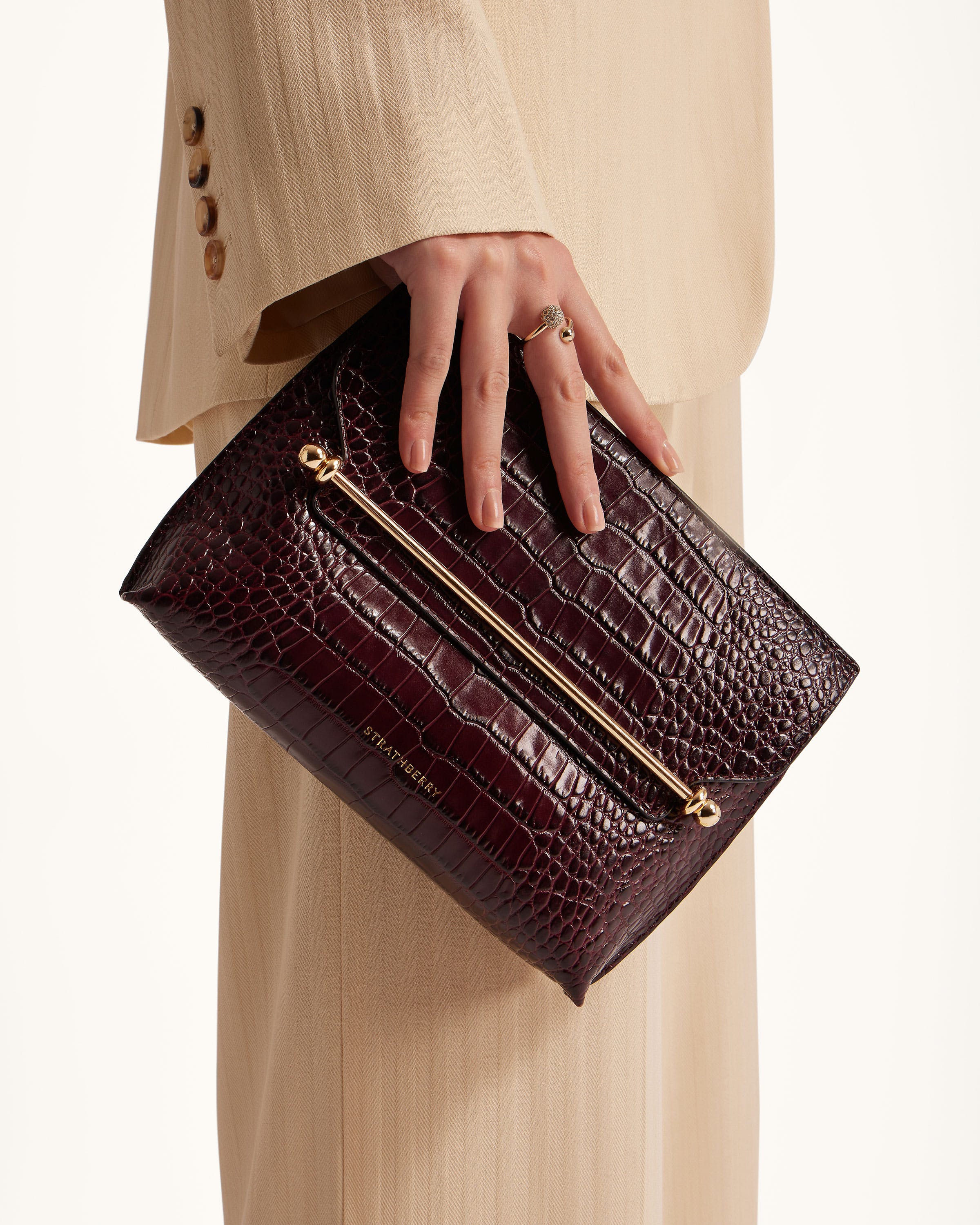 A woman's hand is holding a purse