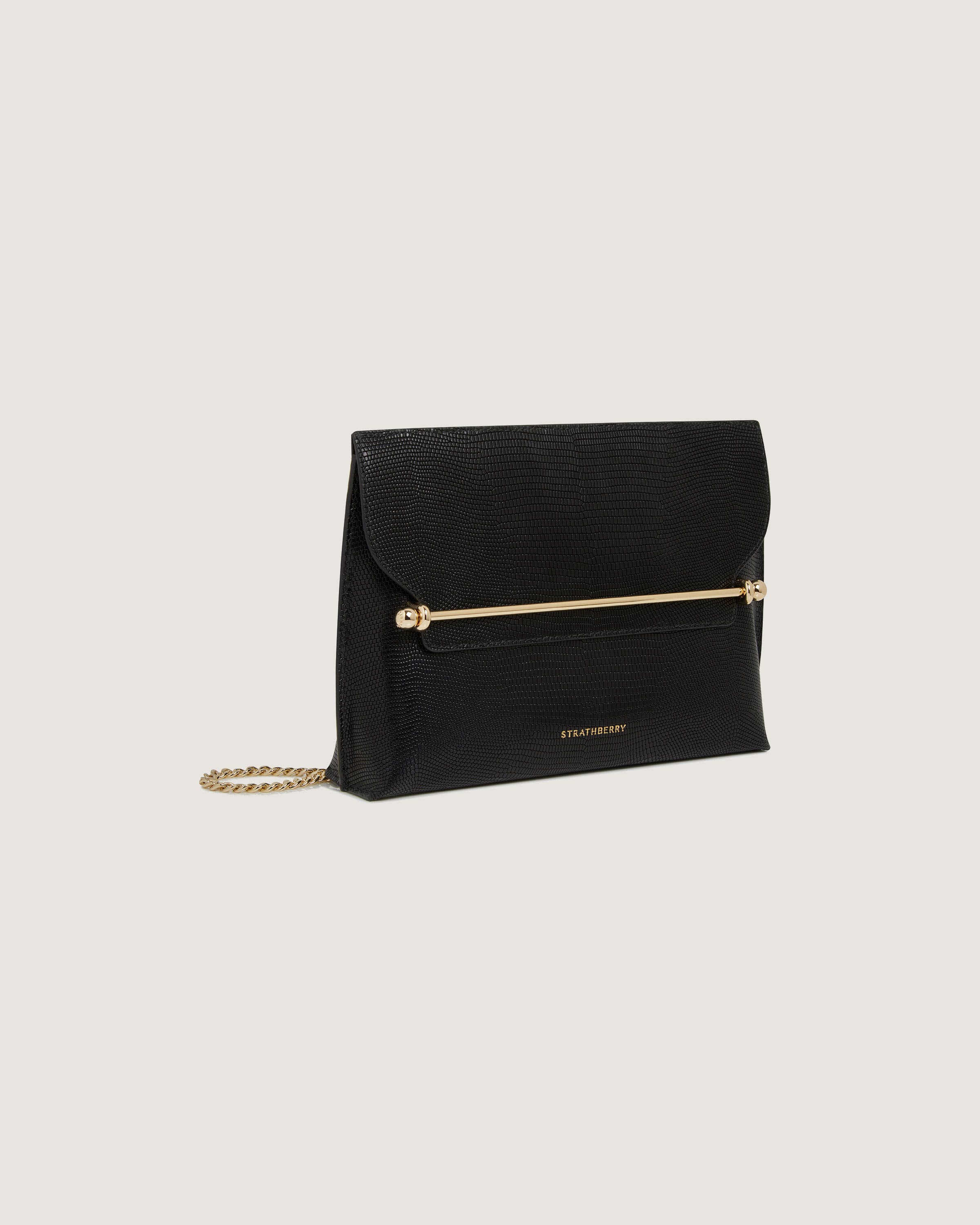 A black clutch bag with a gold chain