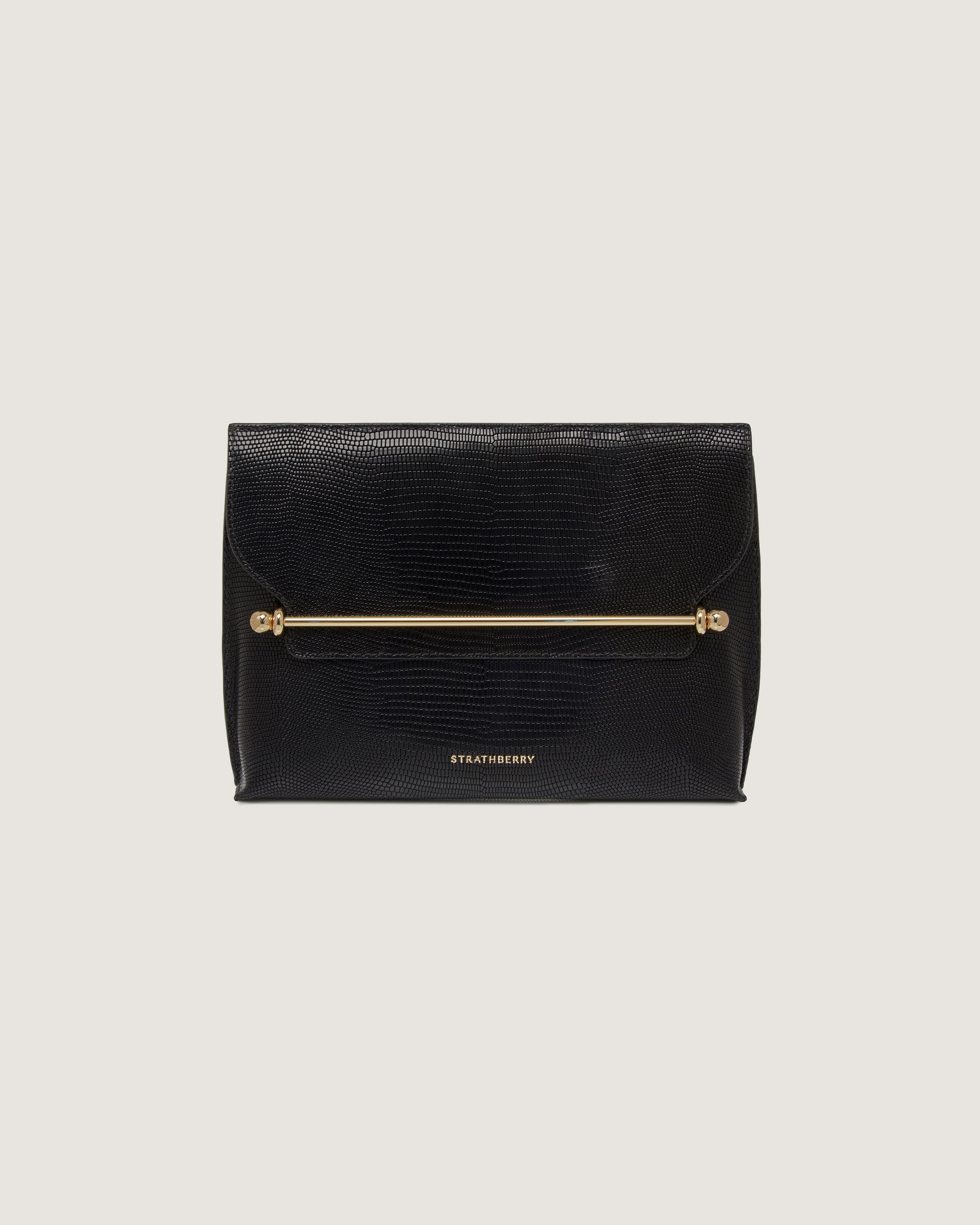 A black clutch bag with a gold handle