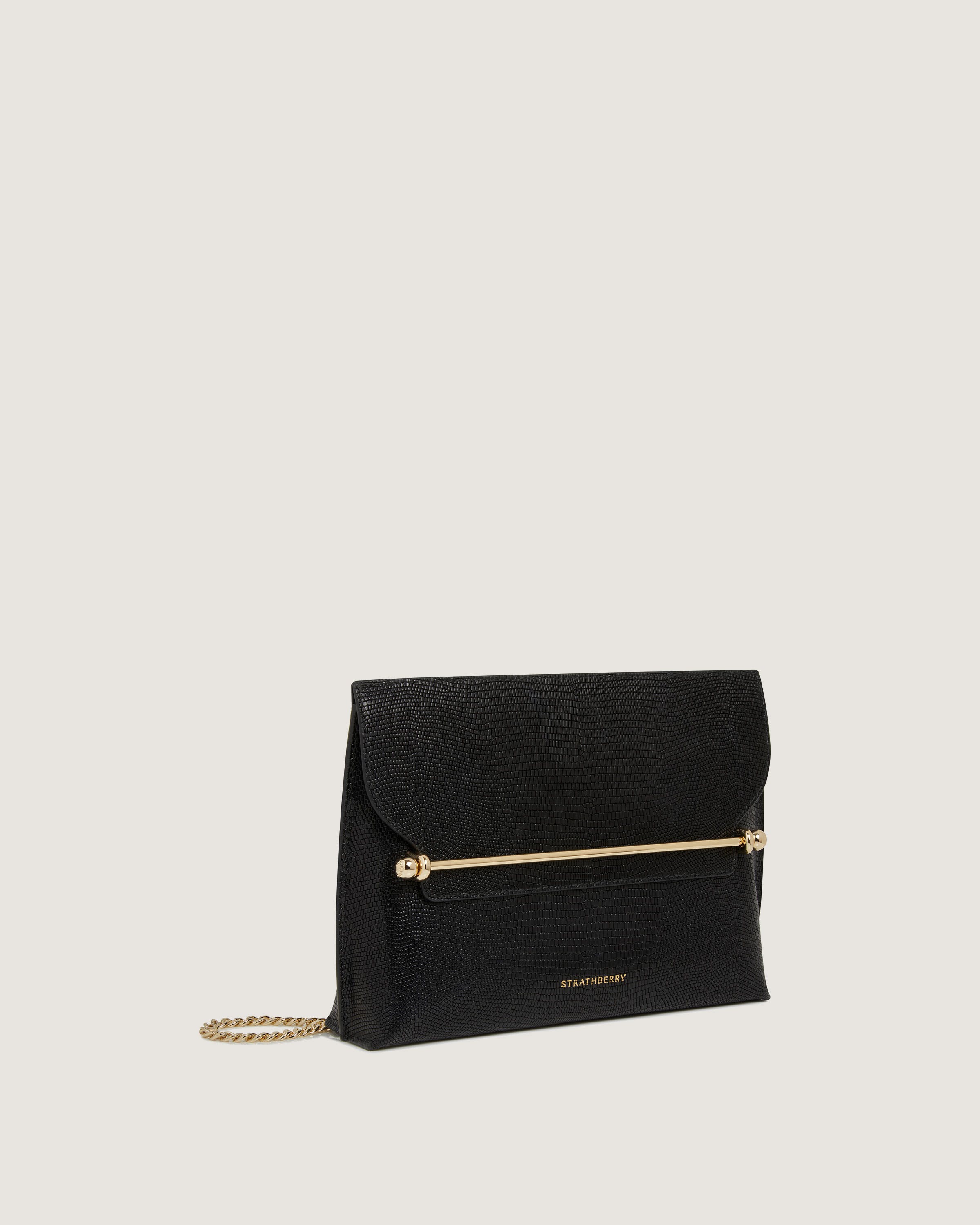 A black clutch bag with a gold chain