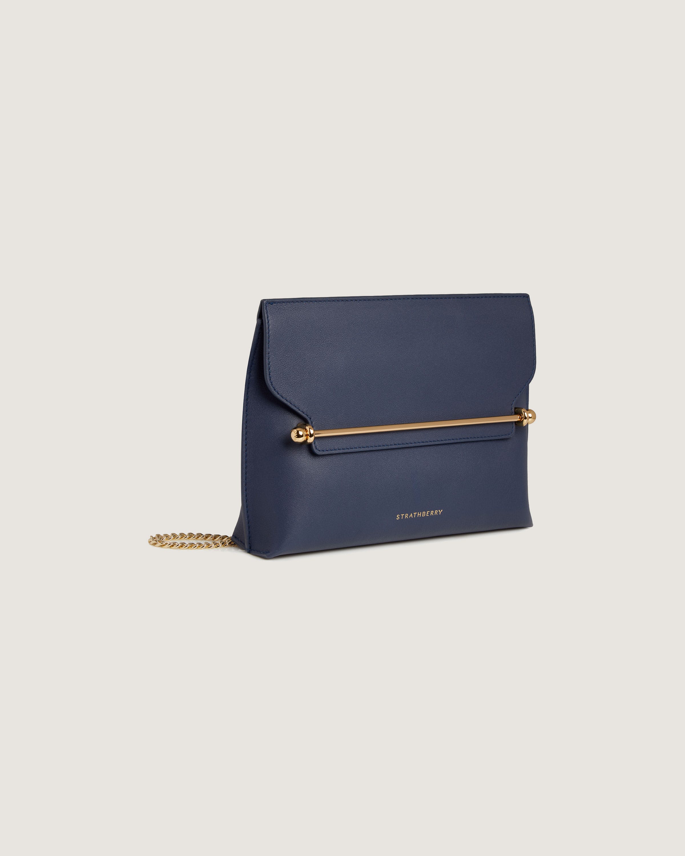 A small blue purse with a gold chain