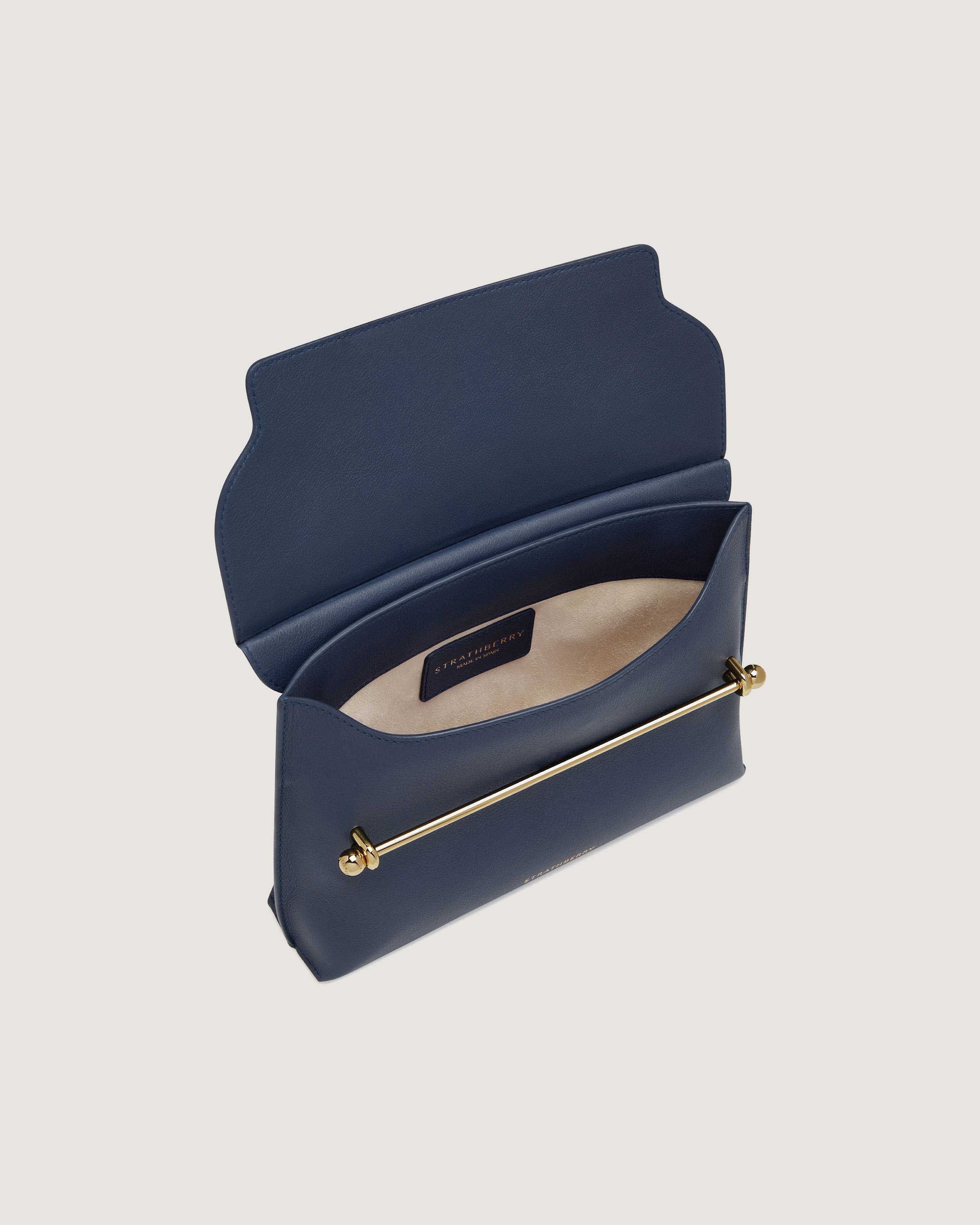 A blue purse with a gold handle