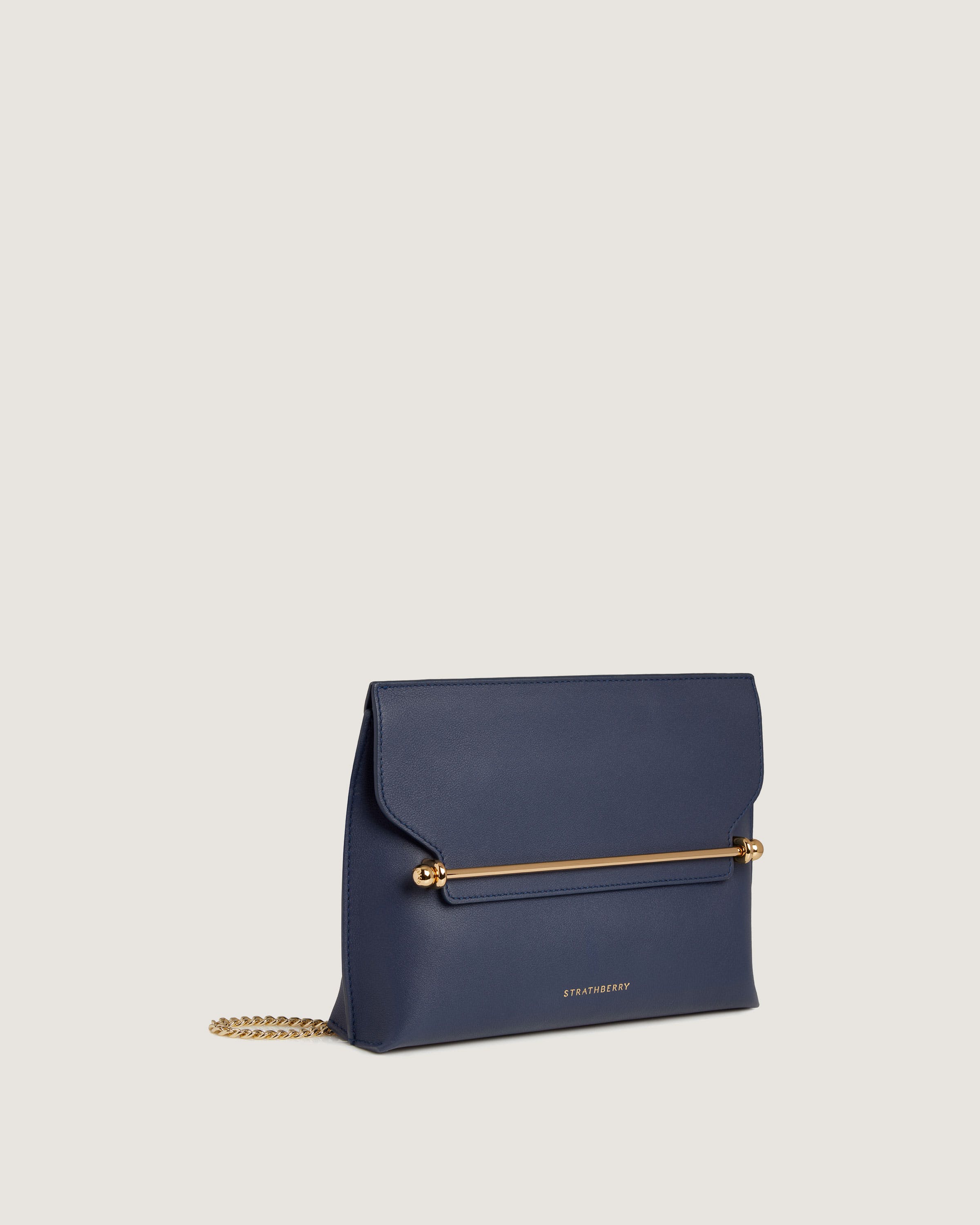 A small blue purse with a gold chain