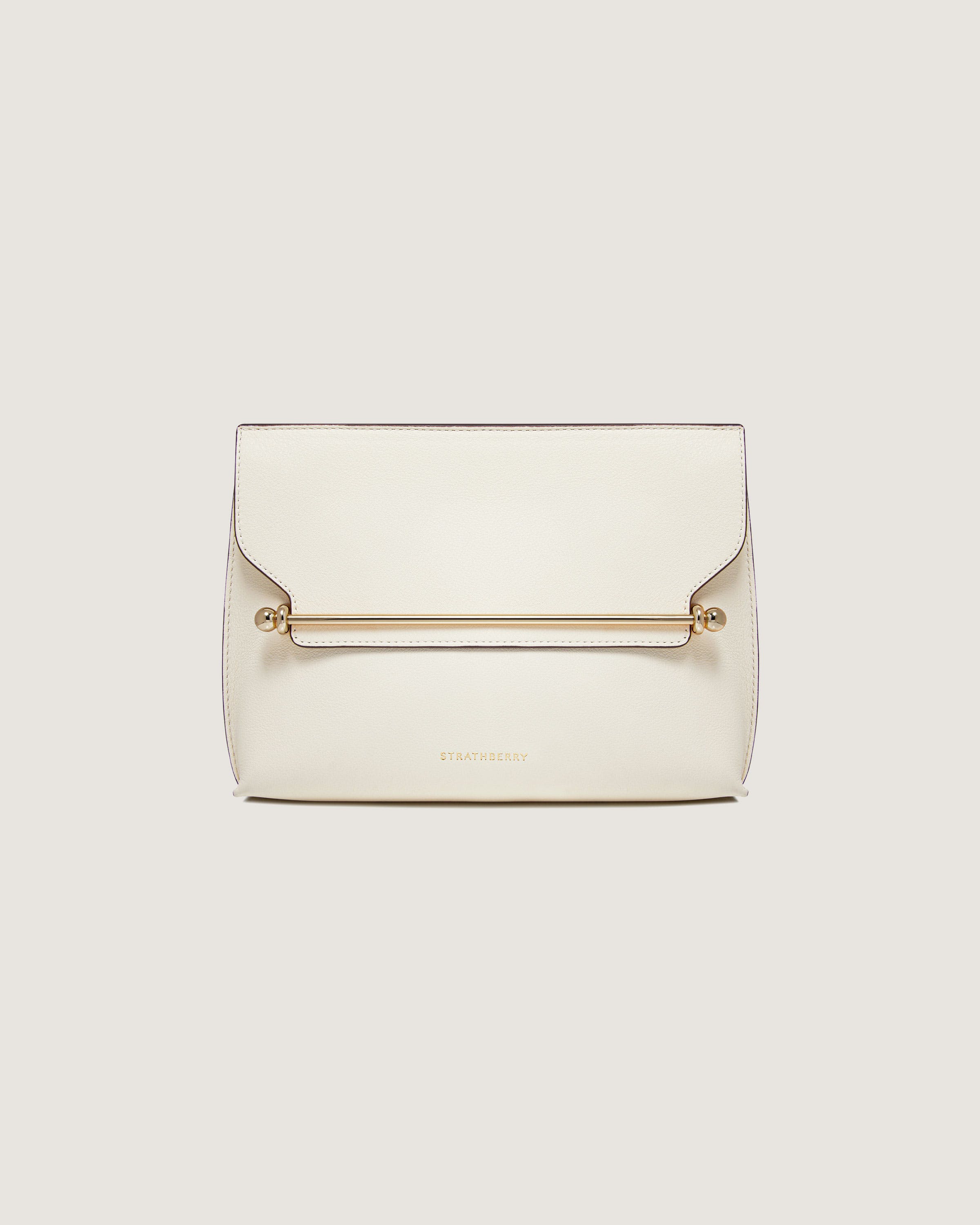 A white clutch bag with a gold handle