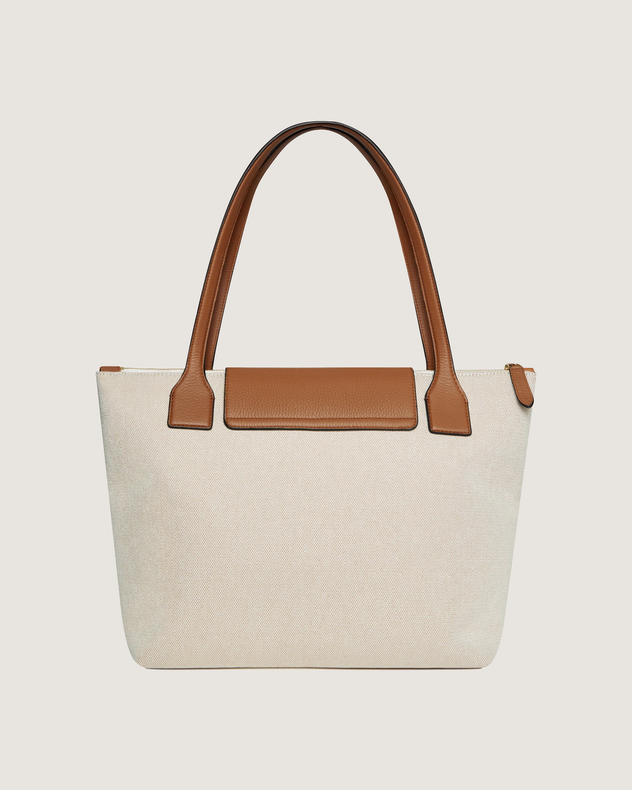 A white and brown bag with a brown handle