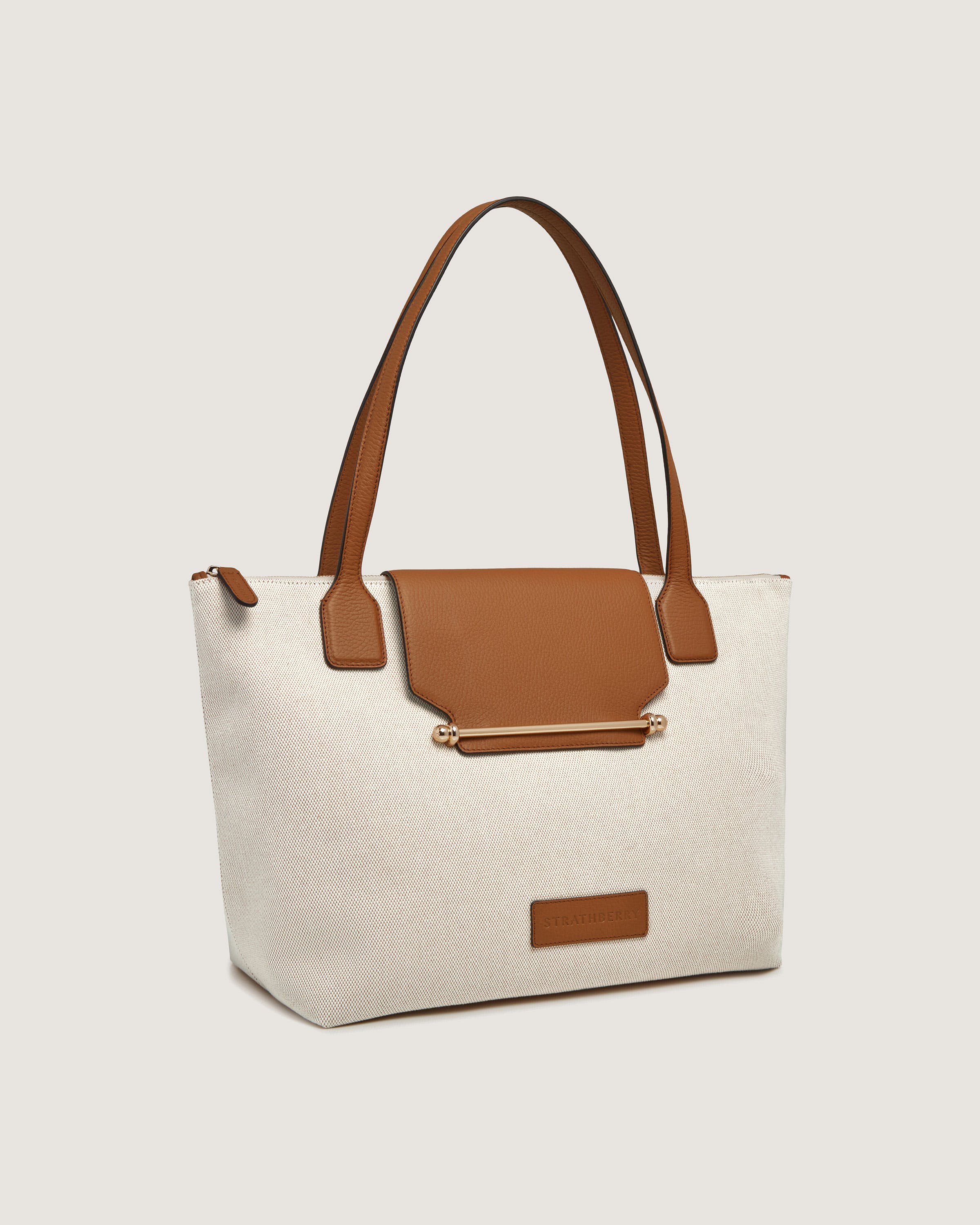 A white and brown bag with a brown handle