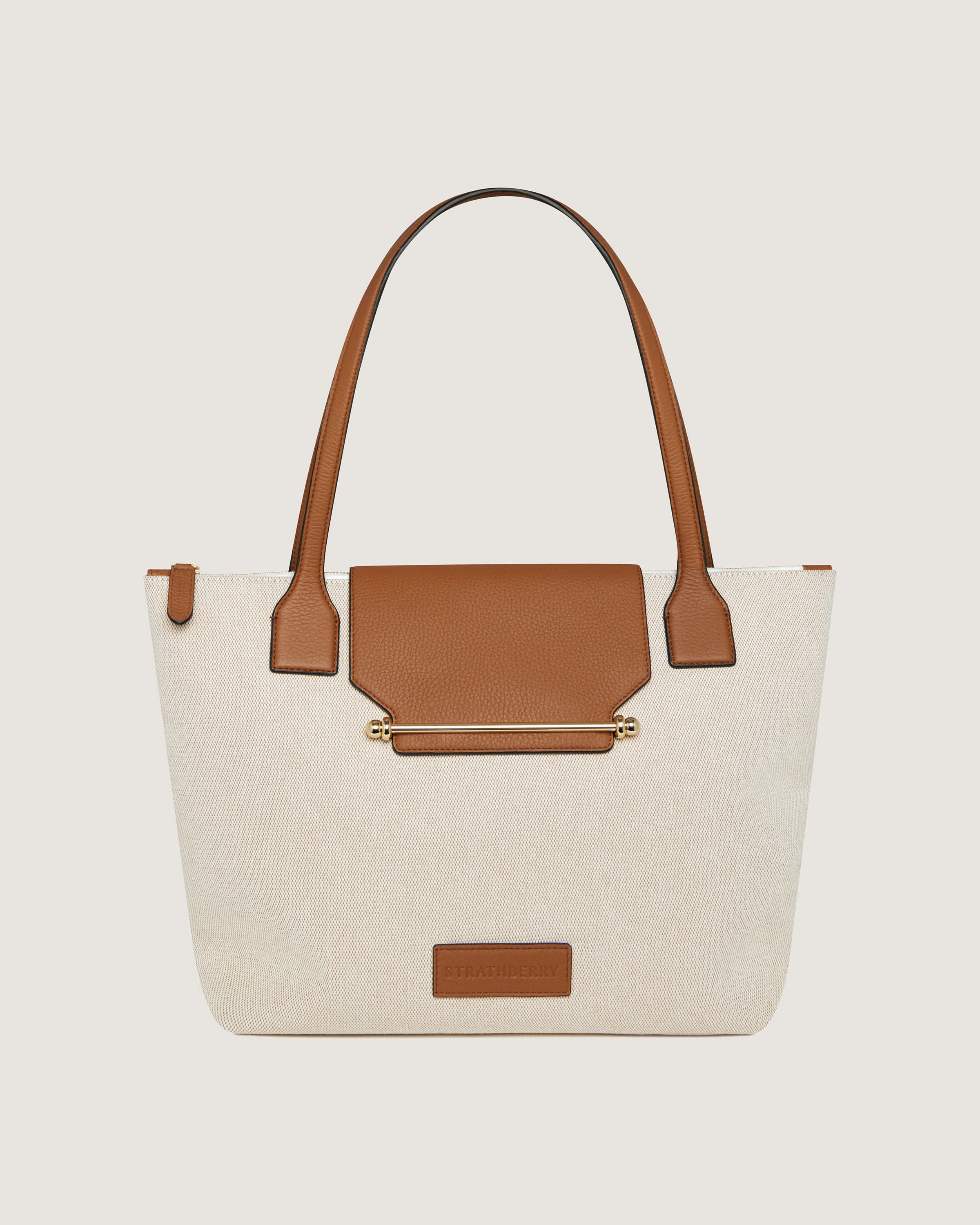 A white and brown handbag with a brown handle