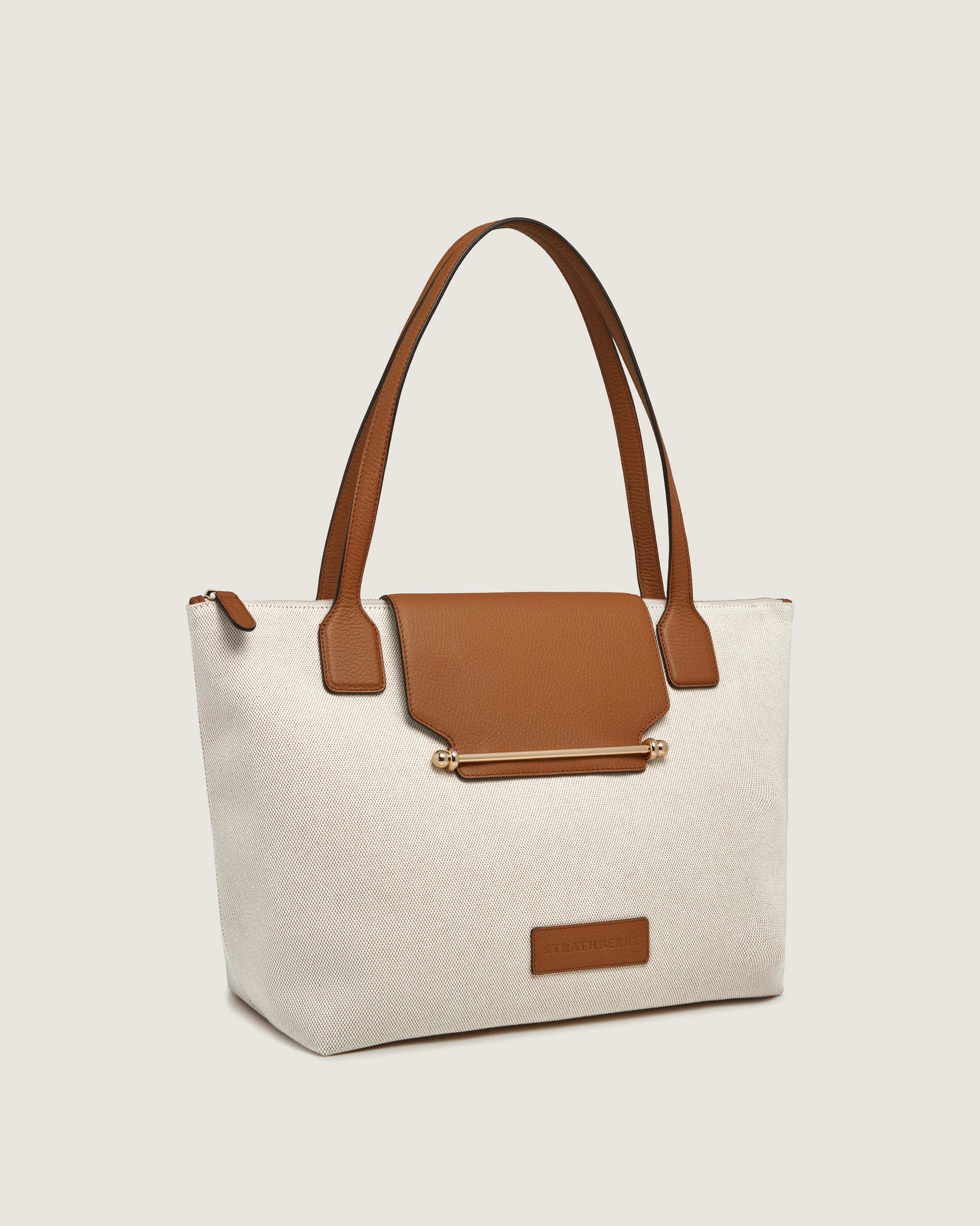 A white and brown bag with a brown handle