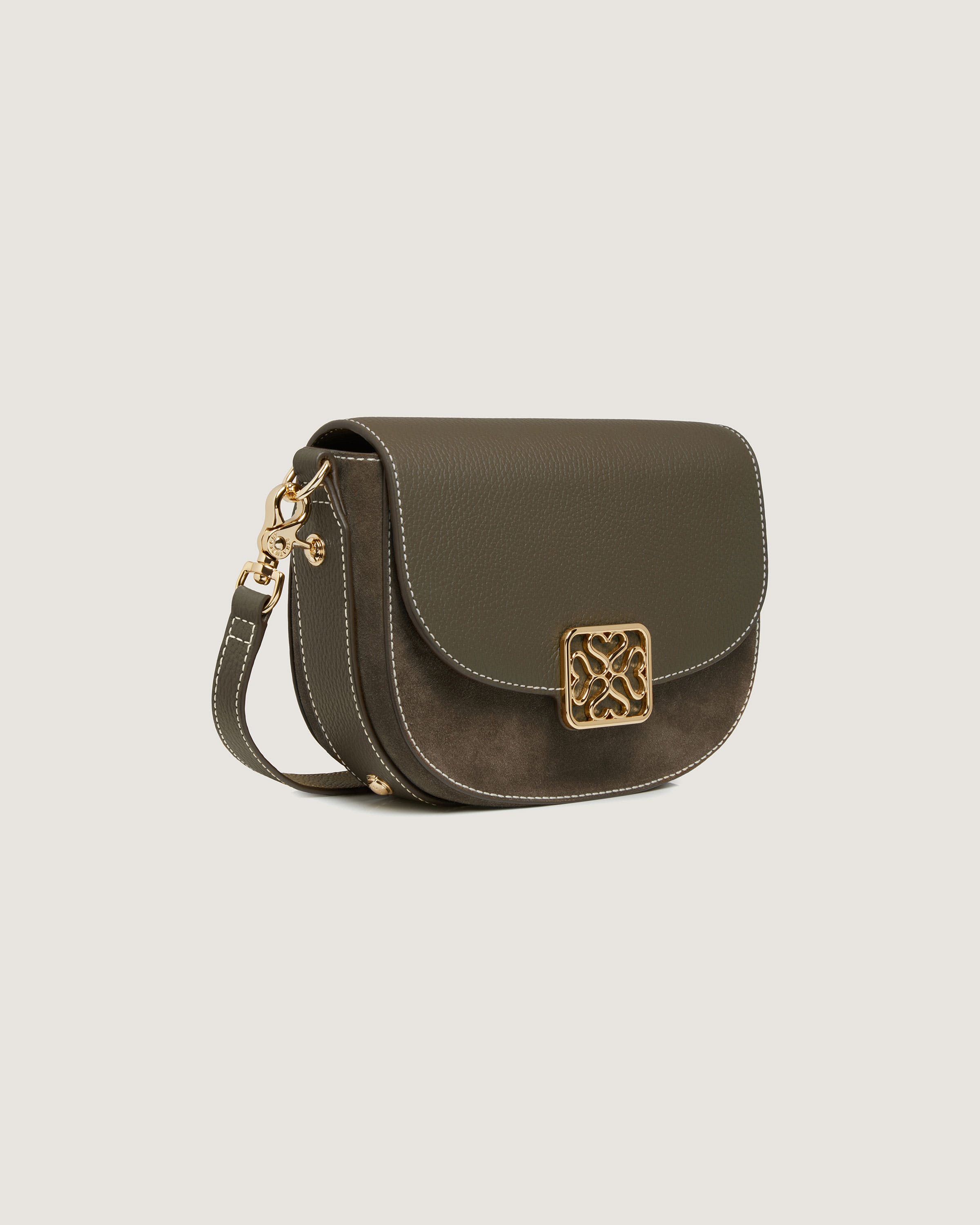 A small cross body bag with a gold buckle