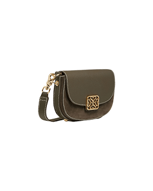 A brown cross body bag on a green background